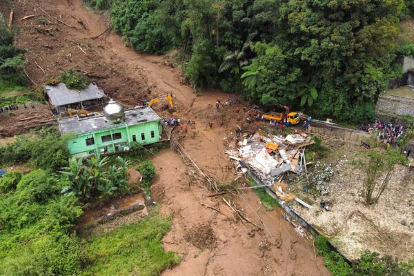 Rescuers search for victims after a landslide that killed a number of people and left some others missing in Karo, North Sumatra, Indonesia, Monday, Nov. 25, 2024. (AP Photo/Binsar Bakkara)