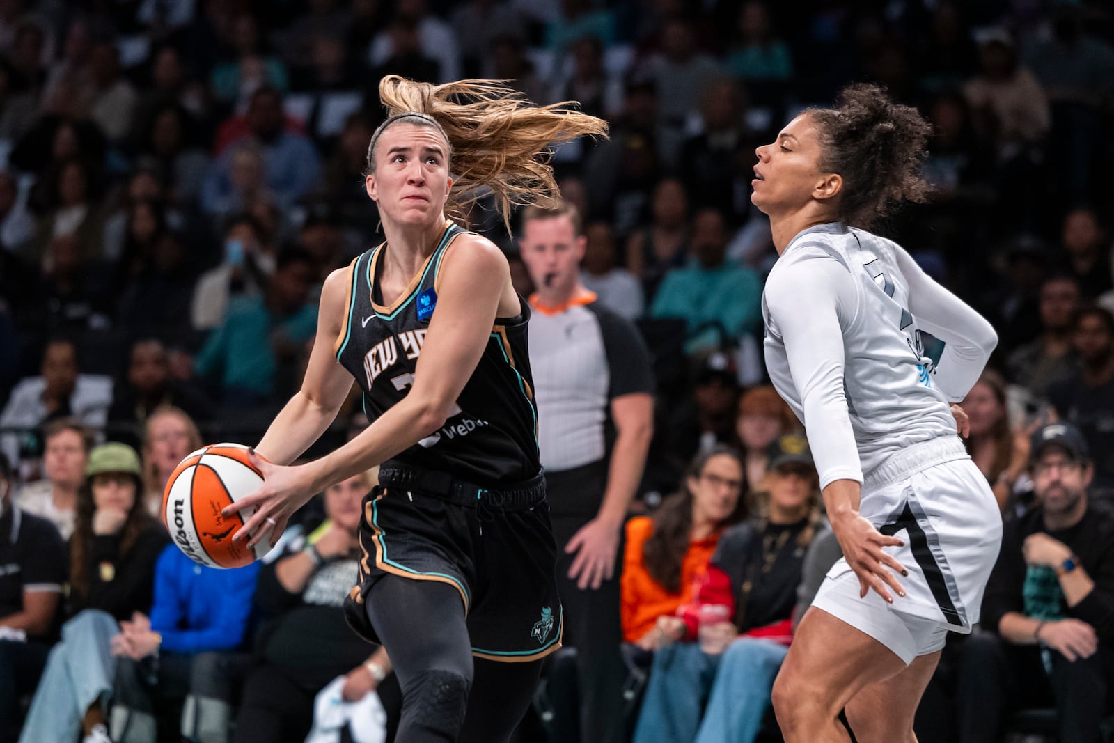 New York Liberty guard Sabrina Ionescu, left, is defended by Las Vegas Aces forward Alysha Clark, right, during the first half of a WNBA basketball second-round playoff game, Sunday, Sept. 29, 2024, in New York. (AP Photo/Corey Sipkin)