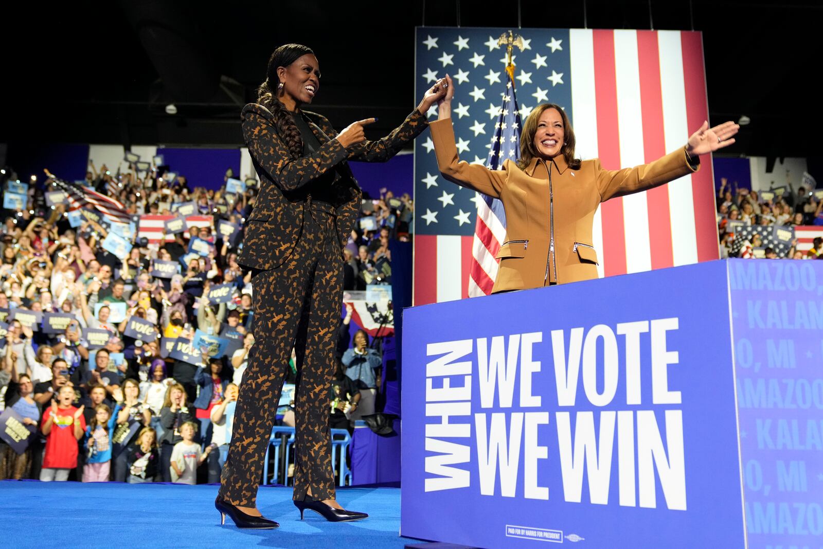 Former first lady Michelle Obama, left, and Democratic presidential nominee Vice President Kamala Harris depart after speaking at a campaign rally at the Wings Event Center in Kalamazoo, Mich. (AP Photo/Jacquelyn Martin)