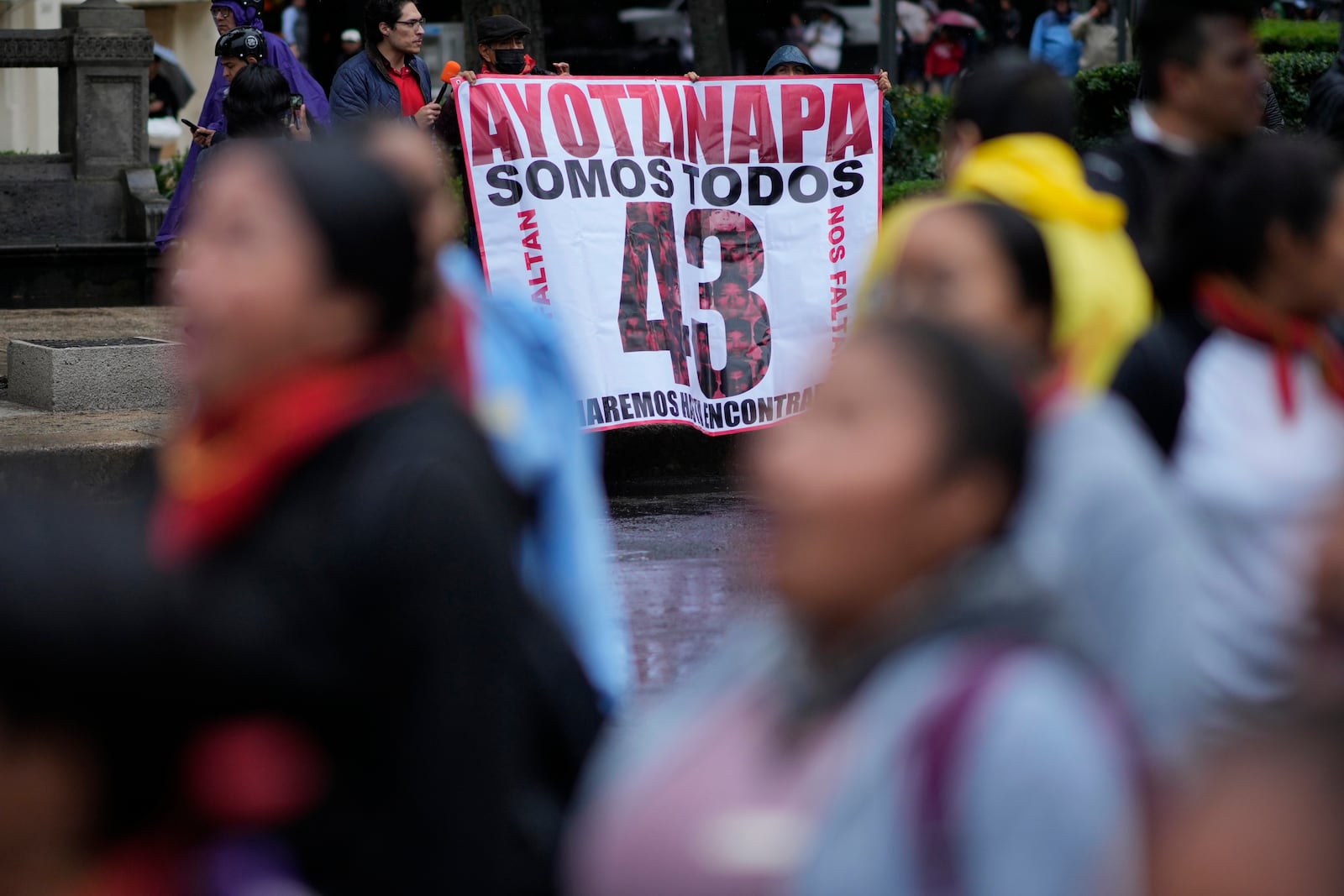 Families and friends take part in a demonstration marking the 10-year anniversary of the disappearance of 43 students from an Ayotzinapa rural teacher's college, in Mexico City, Thursday, Sept. 26, 2024. (AP Photo/Eduardo Verdugo)