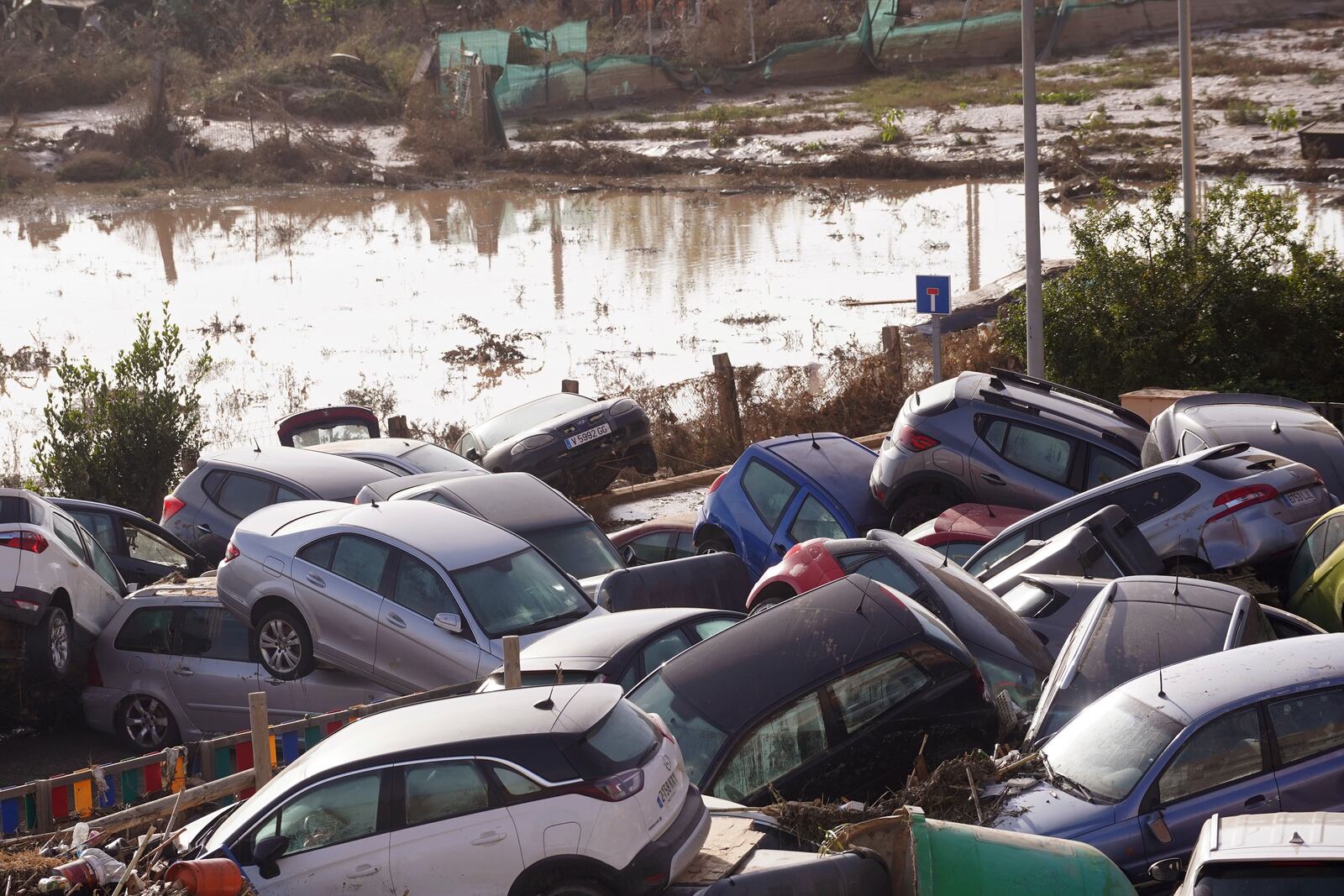 Vehicles are seen piled up after being swept away by floods in Valencia, Spain, Thursday, Oct. 31, 2024. (AP Photo/Alberto Saiz)