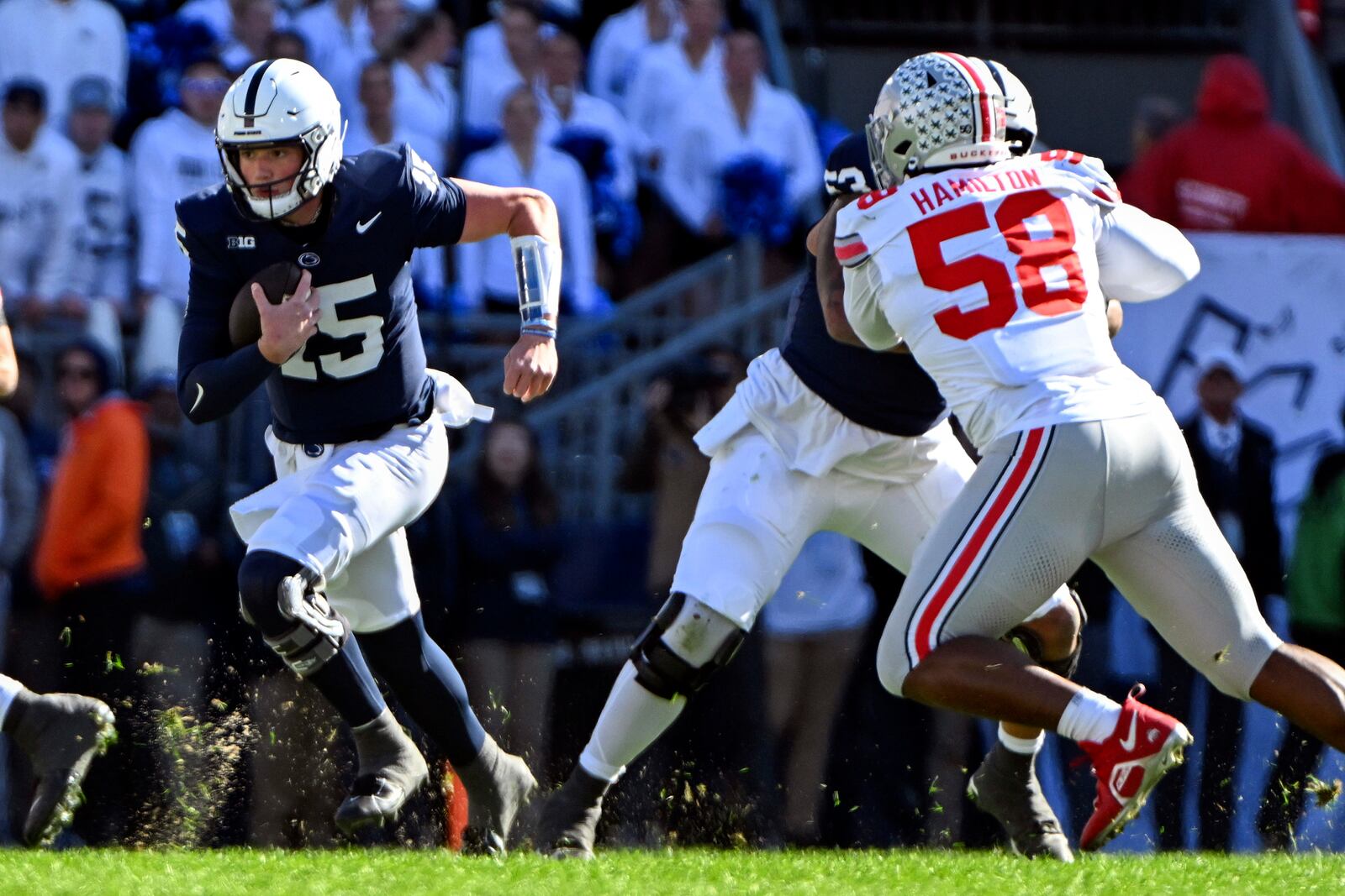 Penn State quarterback Drew Allar (15) gains yardage as Ohio State defensive tackle Ty Hamilton (58) is blocked during the first quarter of an NCAA college football game, Saturday, Nov. 2, 2024, in State College, Pa. (AP Photo/Barry Reeger)