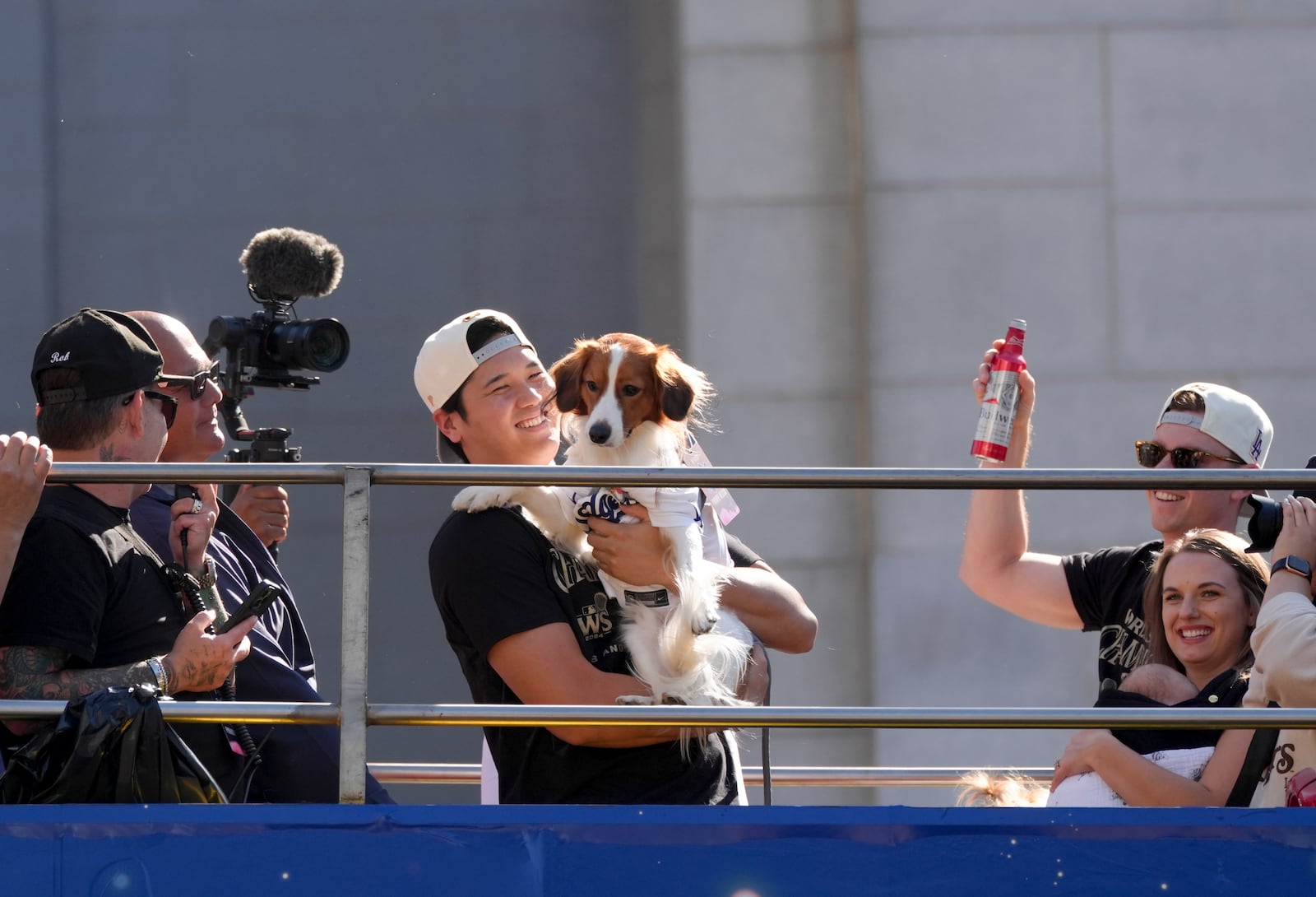 Los Angeles Dodgers' Shohei Ohtani holds his dog Decoy during the Los Angeles Dodgers baseball World Series championship parade Friday, Nov. 1, 2024, in Los Angeles. (AP Photo/Jae C. Hong)