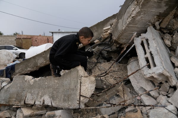 A Palestinian child survey the wreckage left by an Israeli raid in the West Bank city of Jenin, Tuesday, Nov. 19, 2024. (AP Photo/Majdi Mohammed).