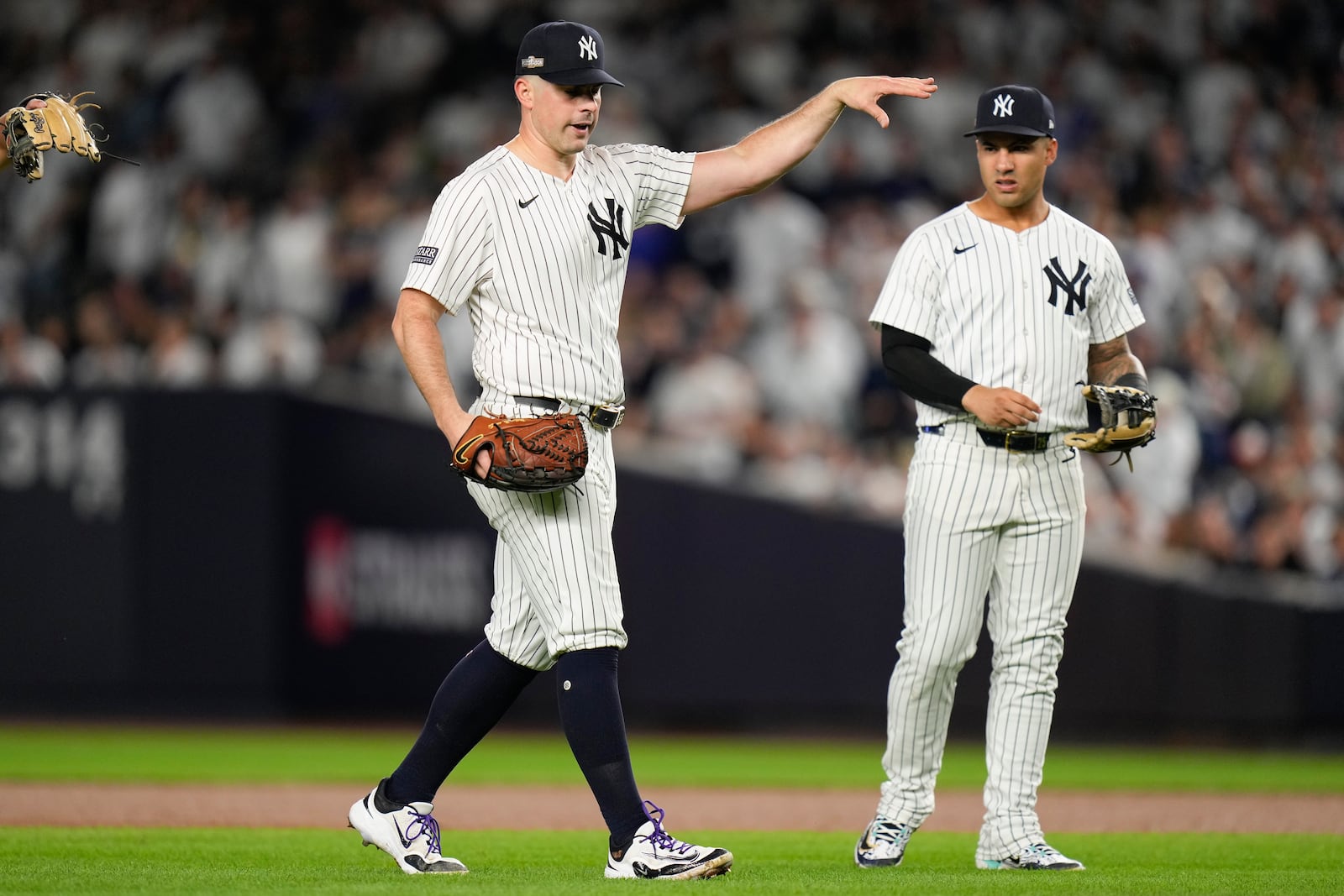 New York Yankees pitcher Carlos Rodón motions to the dugout after knocking down a line drive ball during the third inning of Game 2 of the American League baseball playoff series against the Kansas City Royals, Monday, Oct. 7, 2024, in New York. (AP Photo/Seth Wenig)