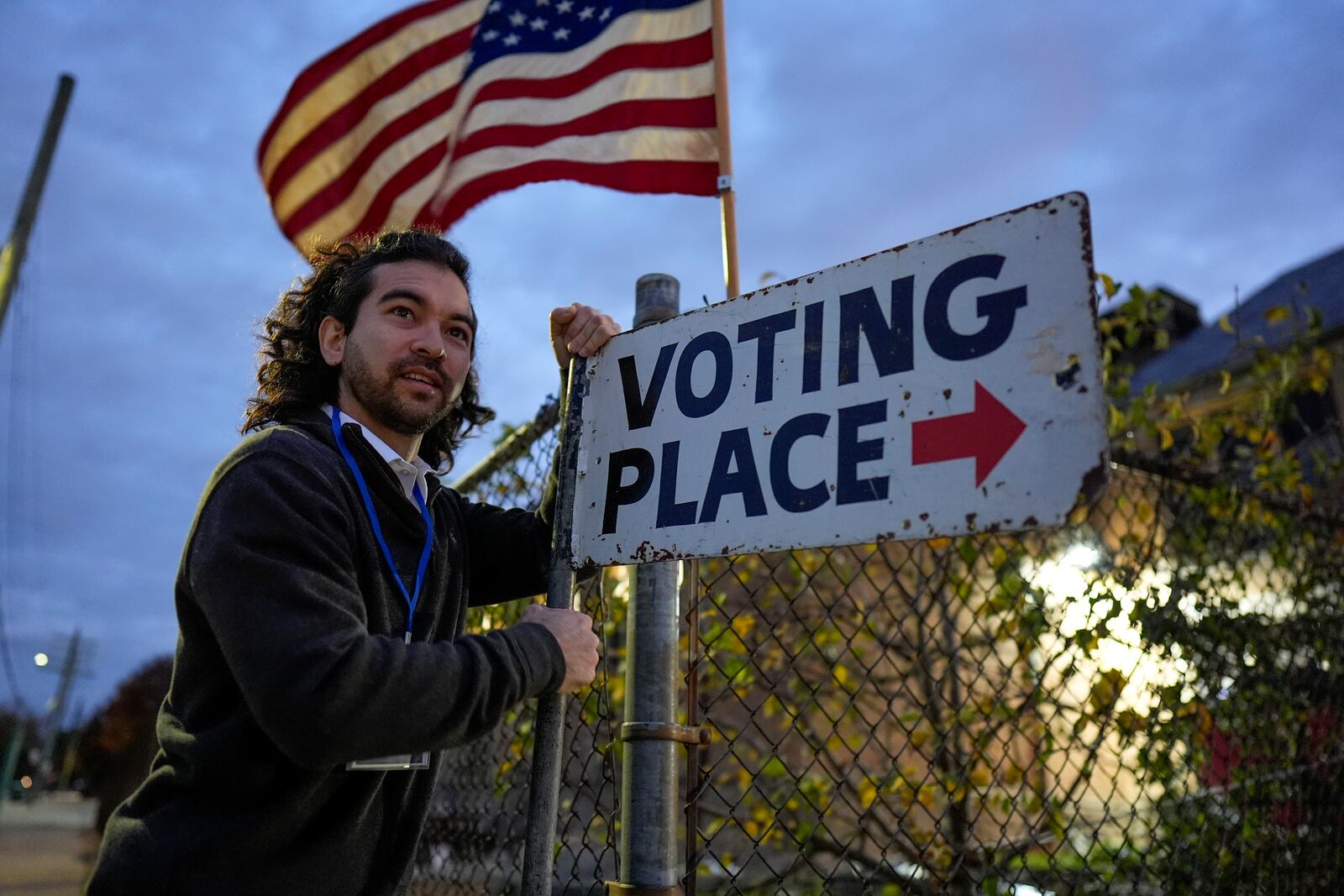 Election day worker Sean Vander Waal prepares to open a polling place,Tuesday, Nov. 5, 2024, in Dearborn, Mich. (AP Photo/Charlie Neibergall)