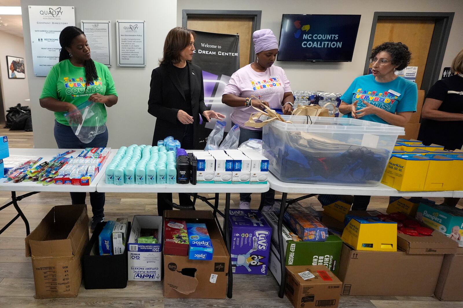 Democratic presidential nominee Vice President Kamala Harris, second left, greets workers at a food drop-off and distribution center after receiving a briefing on the damage from Hurricane Helene, Saturday, October 5, 2024, in Charlotte, N.C. (AP Photo/Chris Carlson)