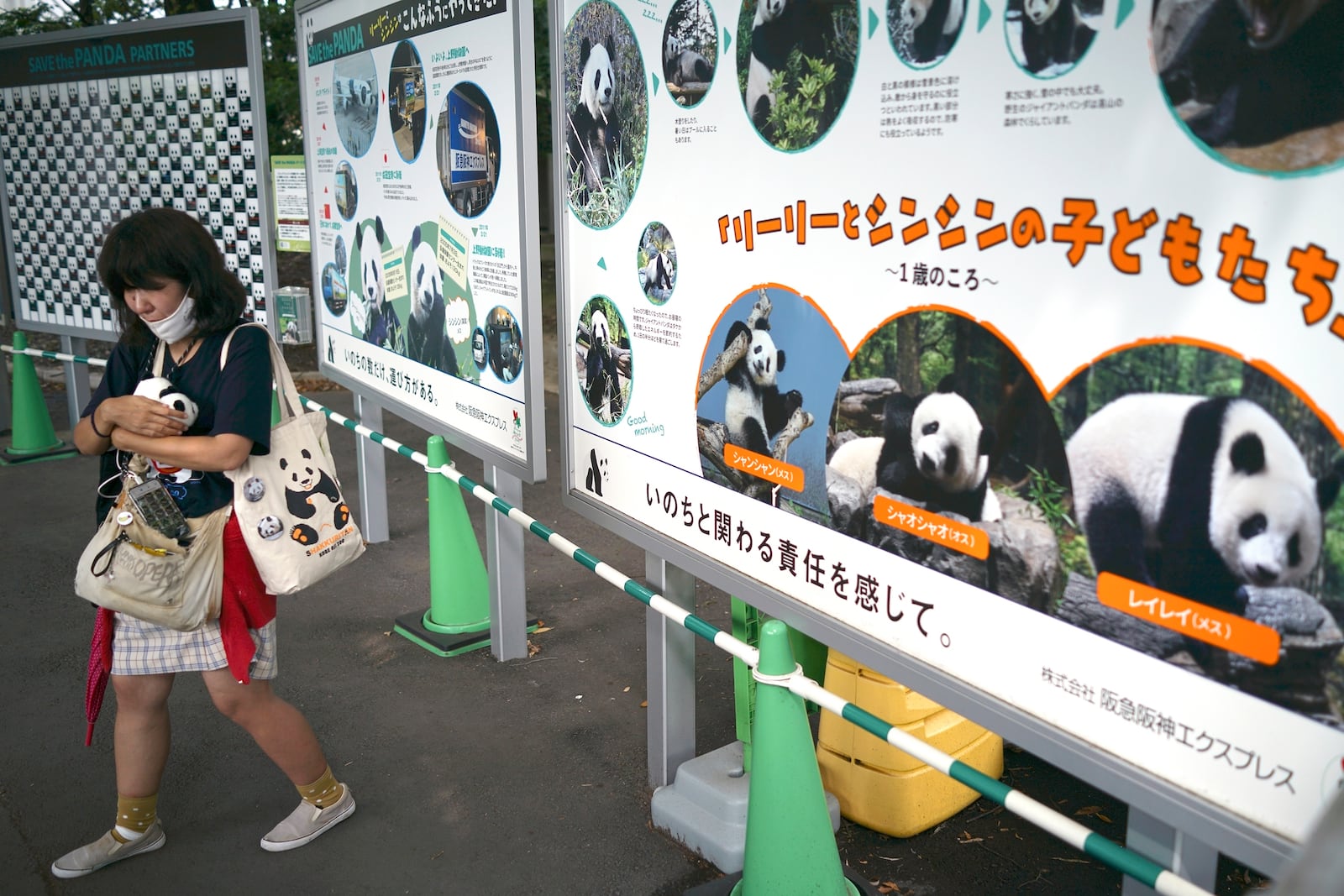 One of visitors reacts after seeing the giant pandas Ri Ri and Shin Shin at Ueno Zoo, a day before their return to China, Saturday, Sept. 28, 2024, in Tokyo. (AP Photo/Eugene Hoshiko)