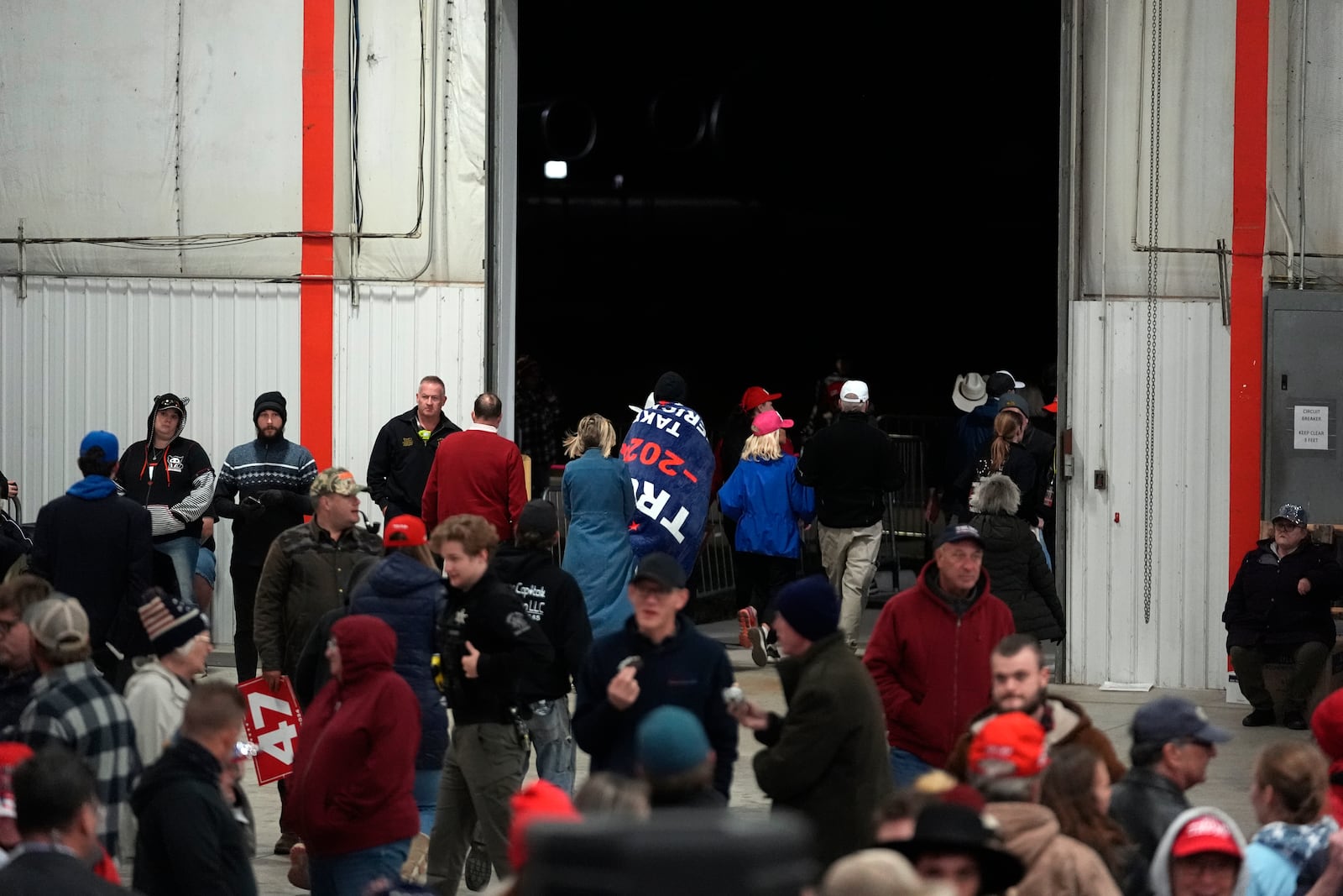 Attendees leave a campaign event for Republican presidential nominee former President Donald Trump before he arrives Friday, Oct. 25, 2024, in Traverse City, Mich. (AP Photo/Paul Sancya)