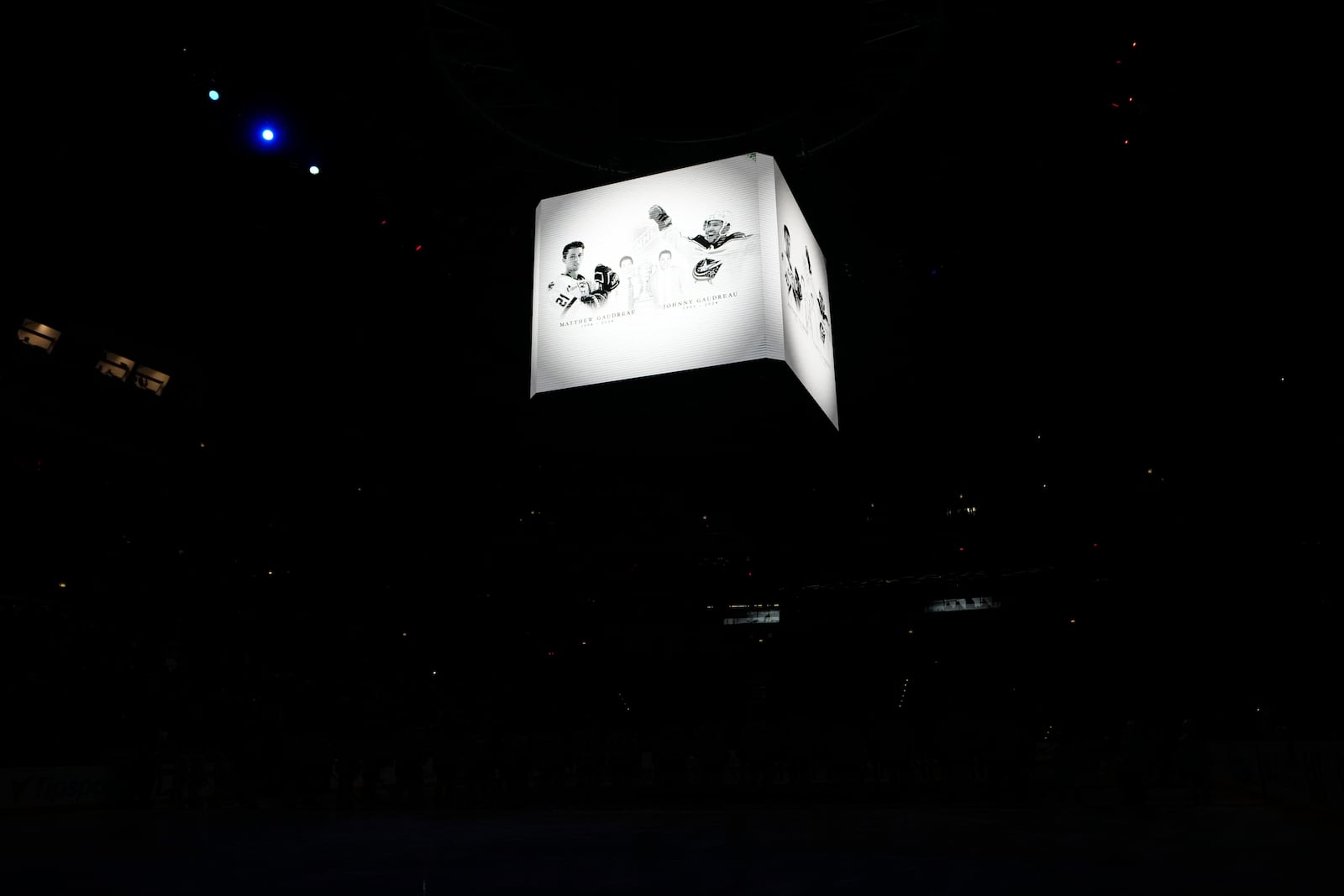 Screens show portraits of Johnny and Matthew Gaudreau during a moment of silence before the NHL hockey game between Buffalo Sabres and New Jersey Devils, in Prague, Czech Republic, Friday, Oct. 4, 2024. (AP Photo/Petr David Josek)