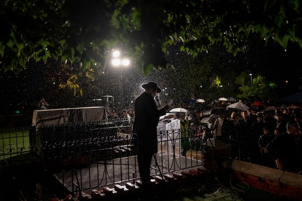 A rabbi gives an eulogy next to the coffin containing the remains of Israeli-Moldovan rabbi Zvi Kogan in Kfar Chabad, Israel, Monday Nov. 25, 2024. Kogan, 28, an ultra-Orthodox rabbi, was killed last week in Dubai where he ran a kosher grocery store. Israelis have flocked for commerce and tourism since the two countries forged diplomatic ties in the 2020 Abraham Accords.(AP Photo/Ohad Zwigenberg)