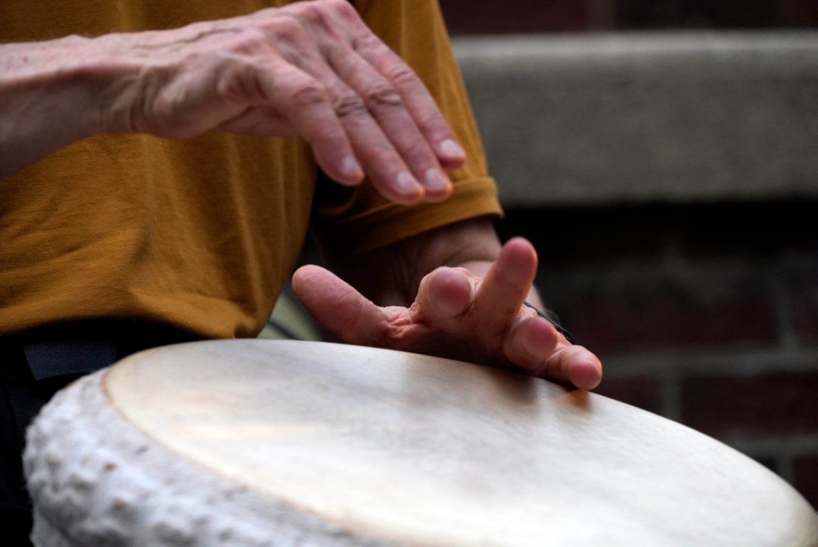 A man plays music at a drum circle Friday, Oct. 4, 2024 in Asheville, N.C., a week after Hurricane Helene upended lives across the Southeast. (AP Photo/Brittany Peterson)