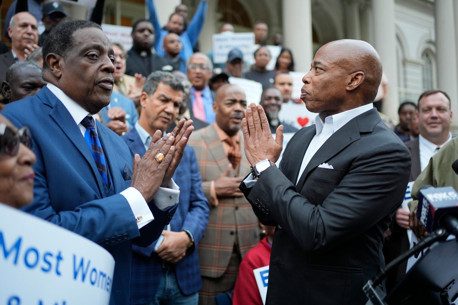 New York City Mayor Eric Adams, right, thanks faith leaders and other supporters during a rally and prayer vigil on the steps of City Hall in New York, Tuesday, Oct. 1, 2024. (AP Photo/Seth Wenig)