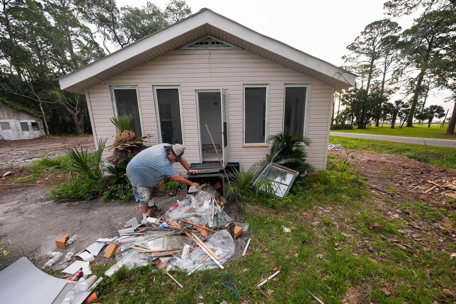 Will Marx cleans up remodeling debris in advance of Tropical Storm Helene, expected to become a hurricane before landfall, in Panacea, Fla., Wednesday, Sept. 25, 2024. (AP Photo/Gerald Herbert)