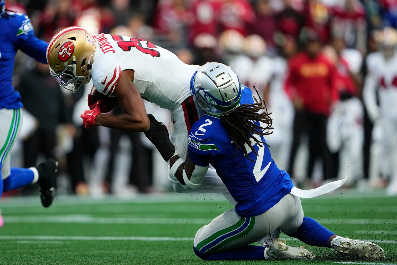 San Francisco 49ers wide receiver Jauan Jennings (15) makes a catch against Seattle Seahawks safety Rayshawn Jenkins (2) during the first half of an NFL football game, Thursday, Oct. 10, 2024, in Seattle. (AP Photo/Lindsey Wasson)