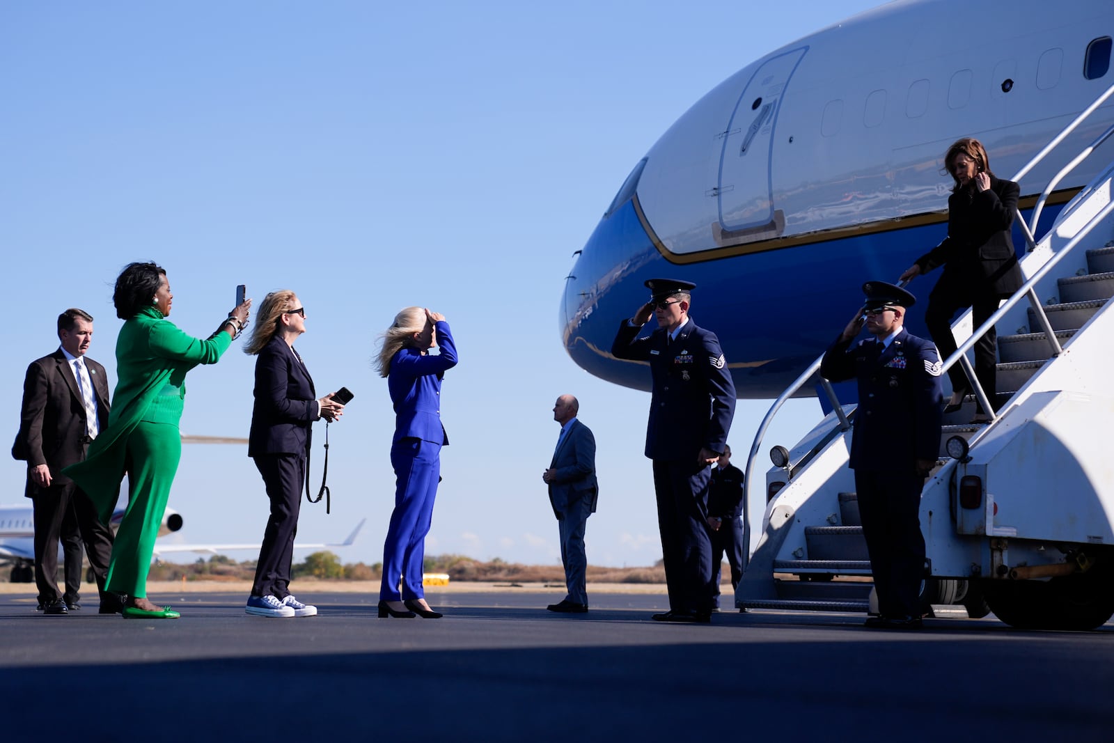 Democratic presidential nominee Vice President Kamala Harris arrives on Air Force Two in Philadelphia, Wednesday, Oct. 23, 2024, and is greeted by from left, Philadelphia Mayor Cherelle Parker (green), Rep. Madeleine Dean, D-Pa., (black), and Rep. Mary Gay Scanlon, D-Pa., (blue). (AP Photo/Matt Rourke)