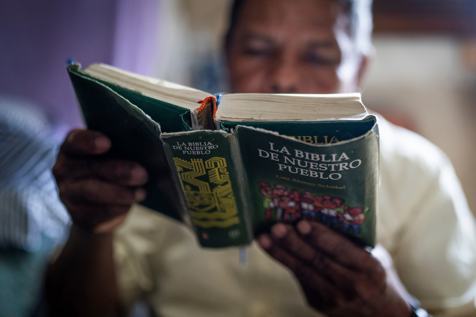 Nicaraguan exile Francisco Alvicio, a deacon of Nicaragua's Moravian Church, reads a Bible in his rented room in San Jose, Costa Rica, Sunday, Sept. 22, 2024. (AP Photo/Carlos Herrera)