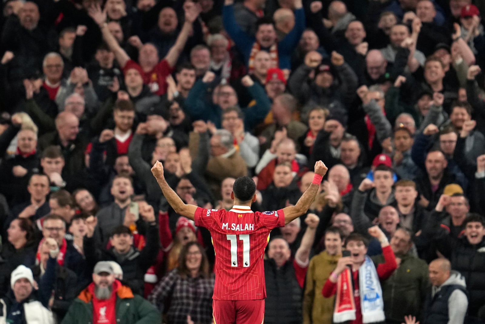 Liverpool's Mohamed Salah celebrates after scoring his side's second goal during the English Premier League soccer match between Liverpool and Brighton at the Anfield stadium in Liverpool, England, Saturday, Nov. 2, 2024. (AP Photo/Jon Super)