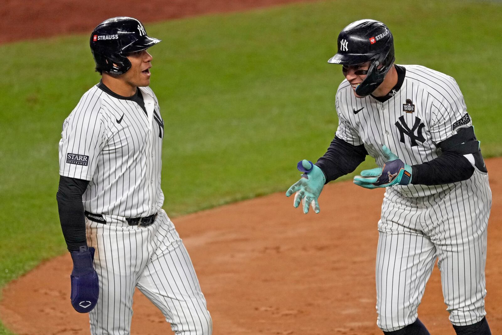 New York Yankees' Aaron Judge, right, celebrates with Juan Soto after both scored on Judge's two-run home run against the Los Angeles Dodgers during the first inning in Game 5 of the baseball World Series, Wednesday, Oct. 30, 2024, in New York. (AP Photo/Seth Wenig)