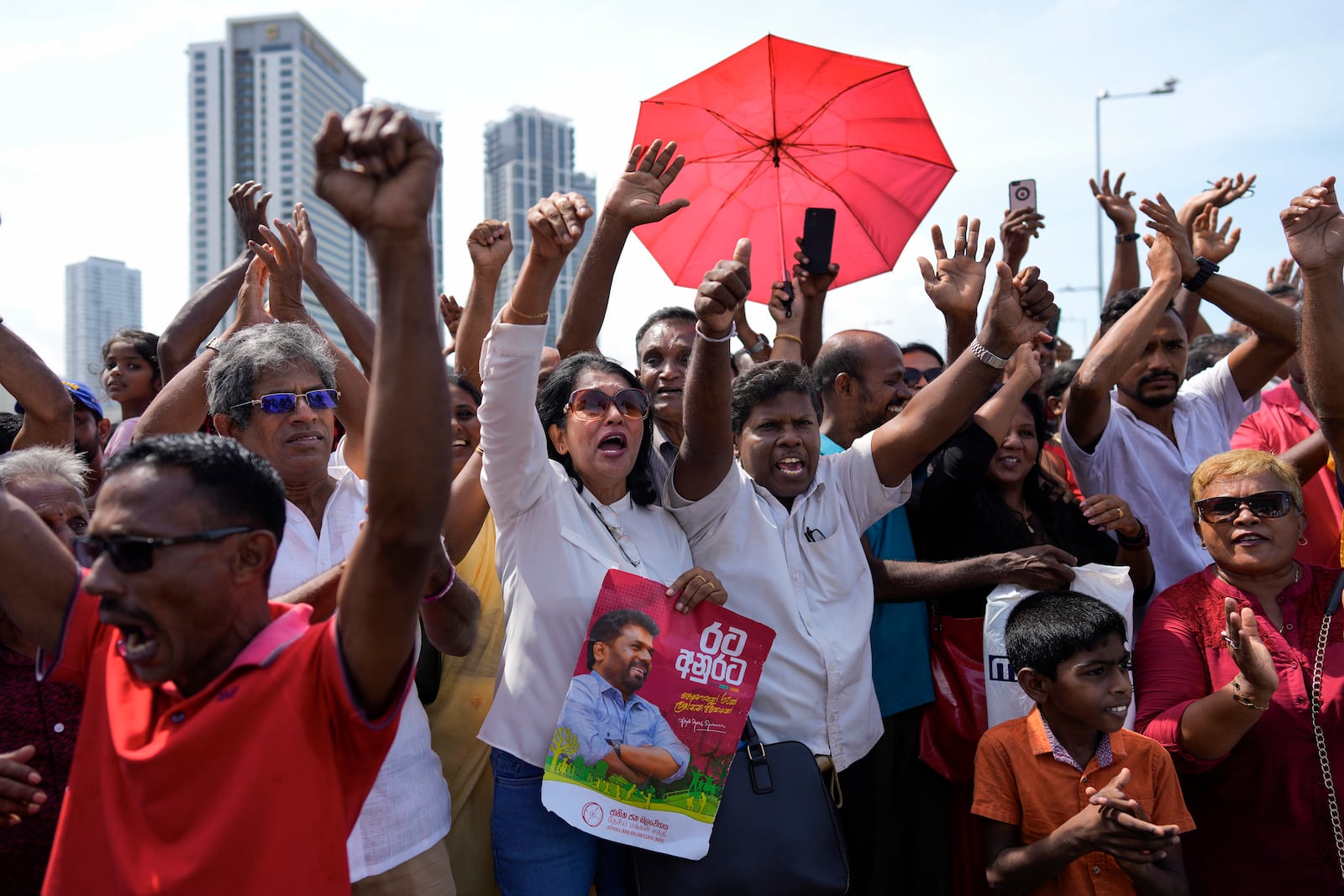 Supporters of Marxist lawmaker Anura Kumara Dissanayake cheer outside the president's office as he arrives to be sworn in as Sri Lanka’s tenth president in Colombo, Sri Lanka, Monday, Sept. 23, 2024. (AP Photo/Eranga Jayawardena)