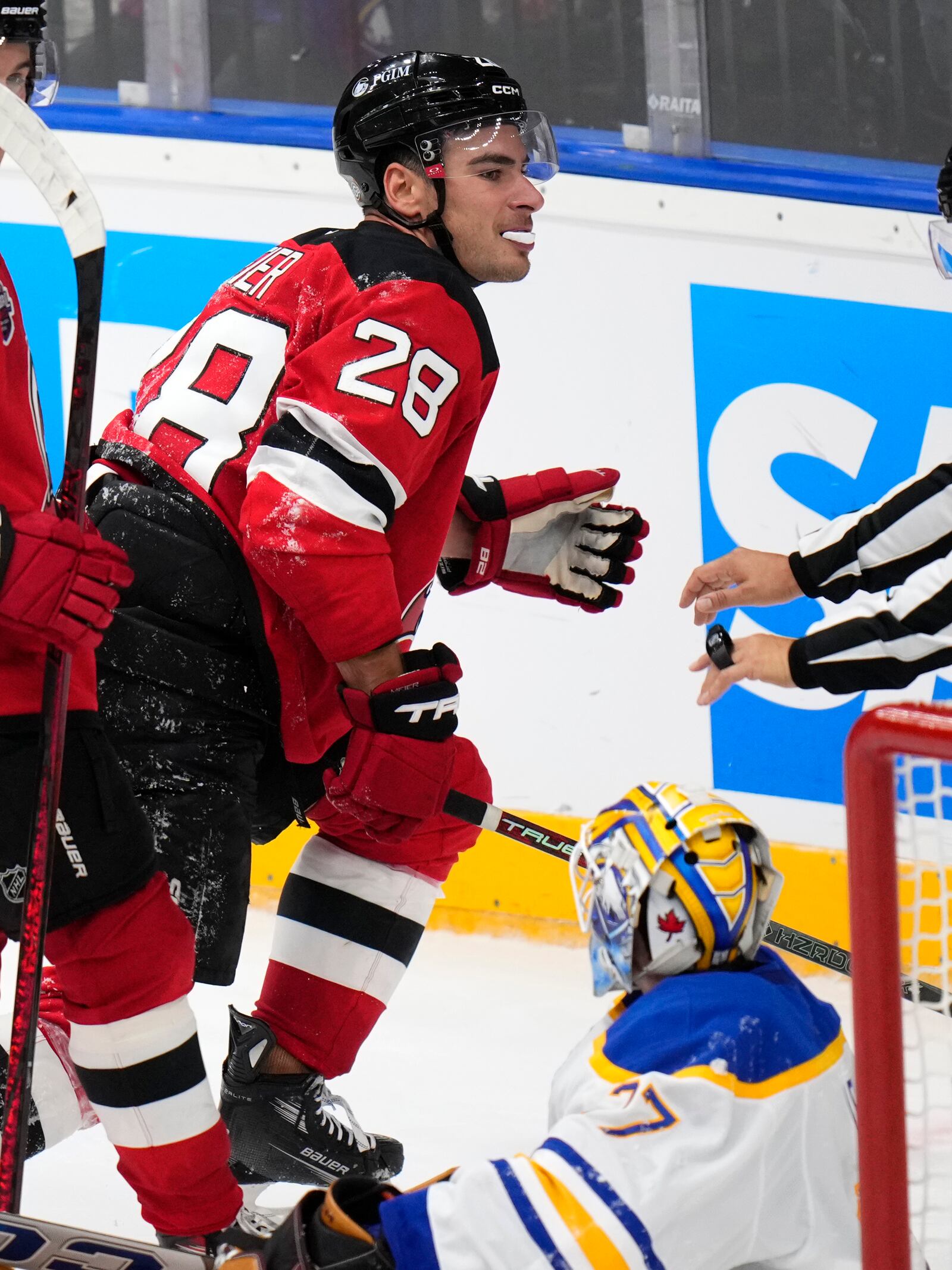 New Jersey Devils' Timo Meier, left, celebrates after scoring his sides third goal past Buffalo Sabres' Devon Levi during the NHL hockey game between Buffalo Sabres and New Jersey Devils, in Prague, Czech Republic, Saturday, Oct. 5, 2024. (AP Photo/Petr David Josek)