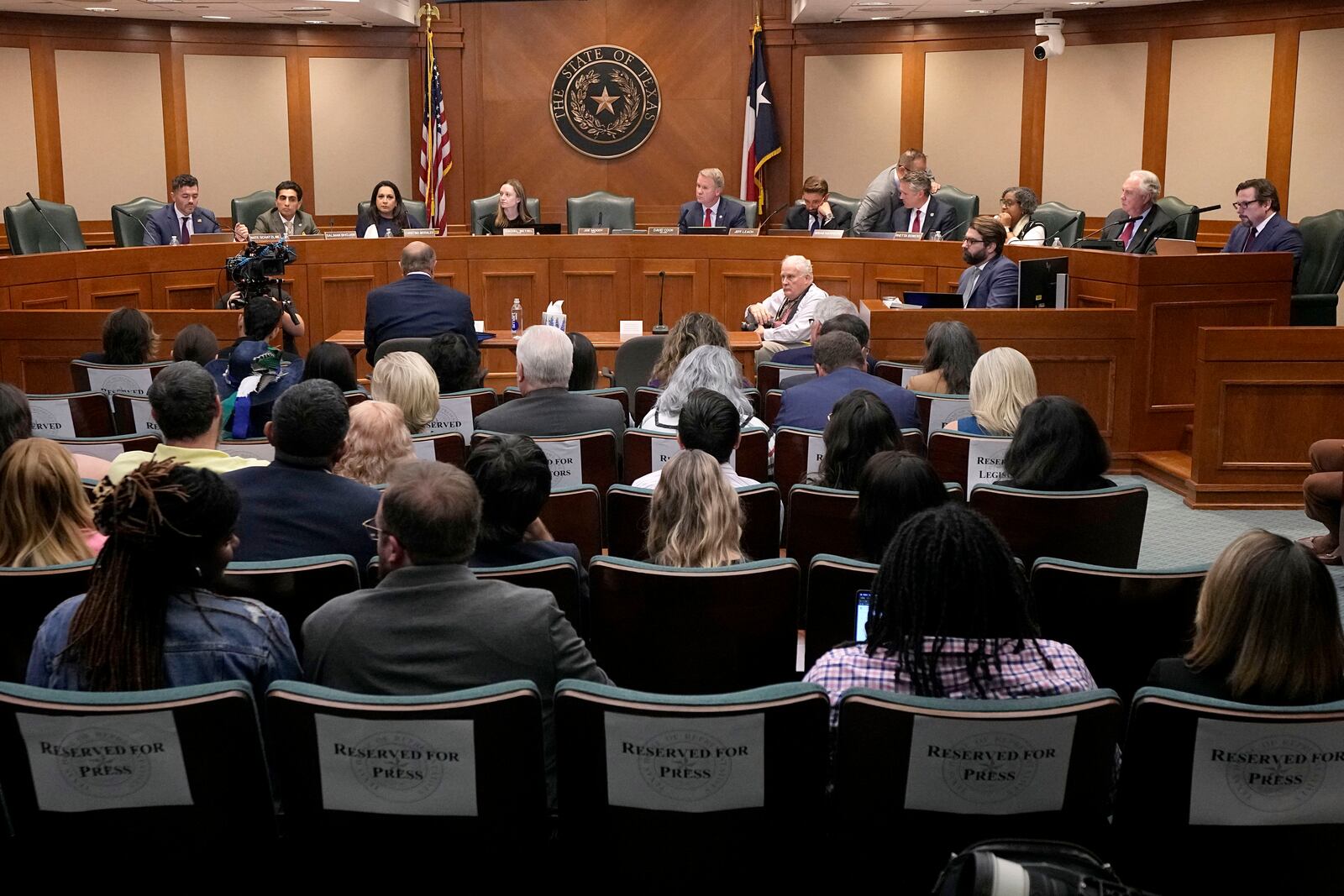 Dr. Phil McGraw, in blue suit sitting at table, gives testimony to the state House Committee on Criminal Jurisprudence during a committee hearing in the case of death row inmate Robert Roberson, Monday, Oct. 21, 2024, in Austin, Texas. (AP Photo/Tony Gutierrez)