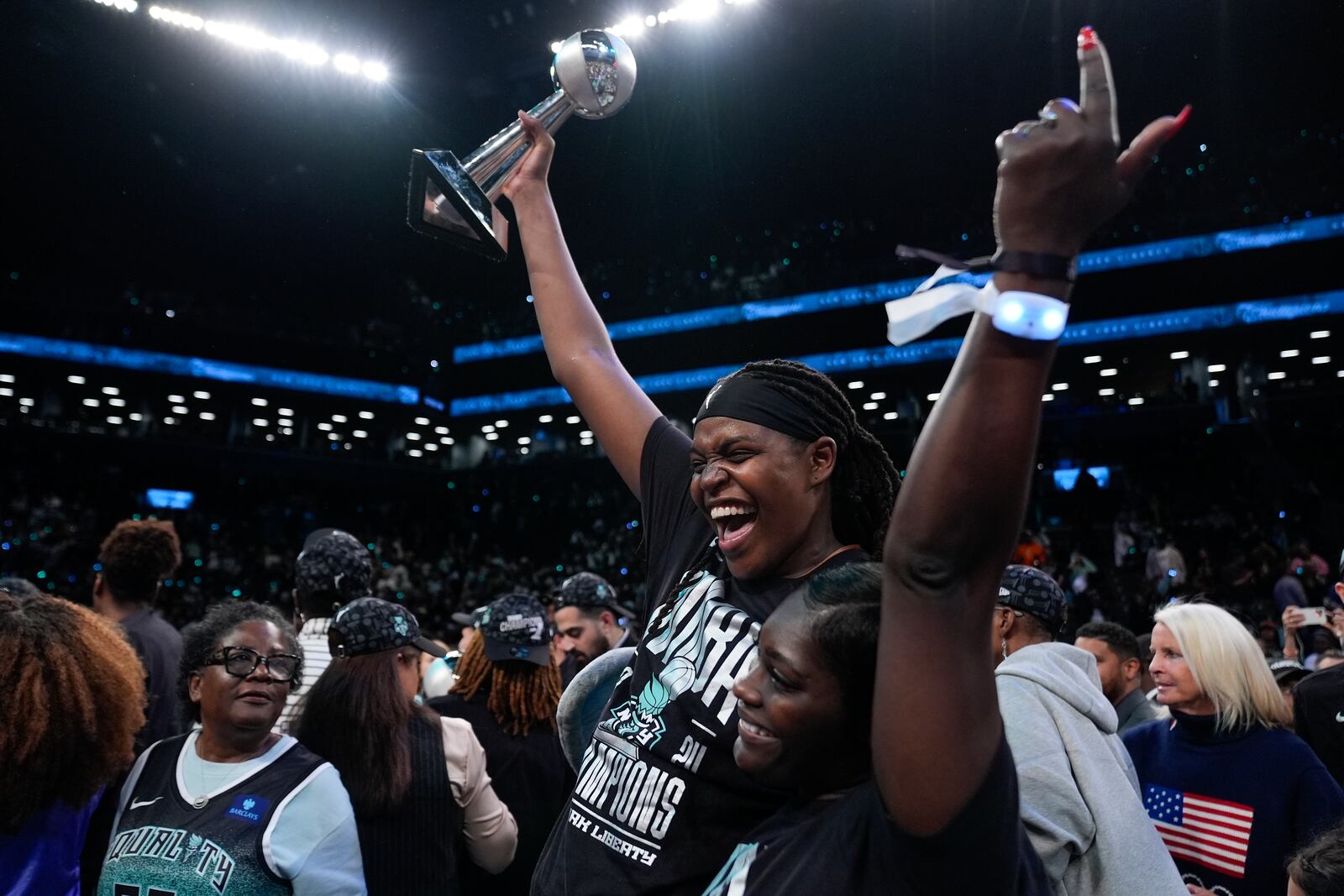 New York Liberty forward Jonquel Jones, left, holds up the MVP award after the Liberty defeated the Minnesota Lynx in Game 5 of the WNBA basketball final series, Sunday, Oct. 20, 2024, in New York. (AP Photo/Pamela Smith)