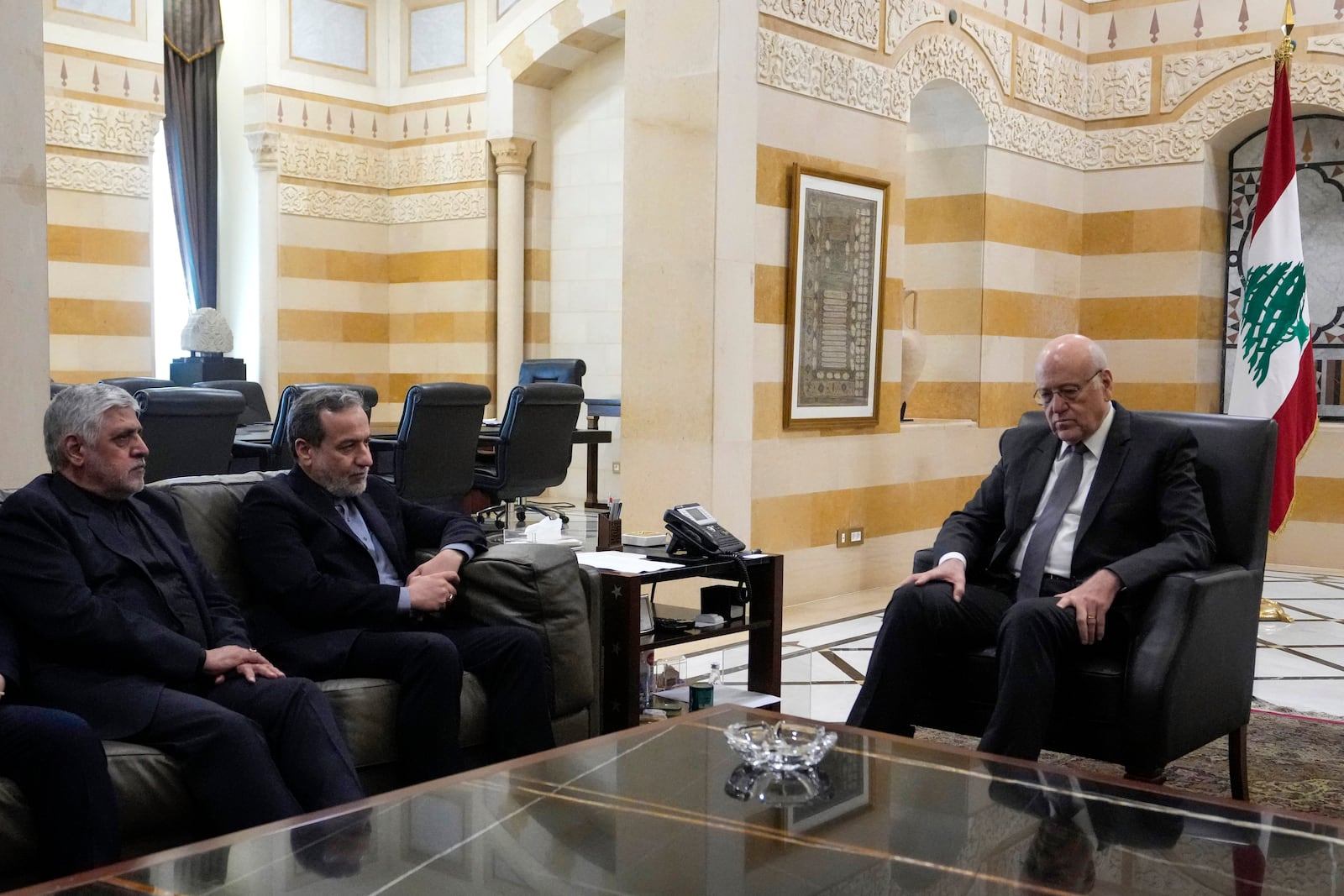 Iranian Foreign Minister Abbas Araghchi, second left, meets with Lebanese caretaker Prime Minister Najib Mikati, right, in Beirut, Lebanon, Friday, Oct. 4, 2024. (AP Photo/Hassan Ammar)