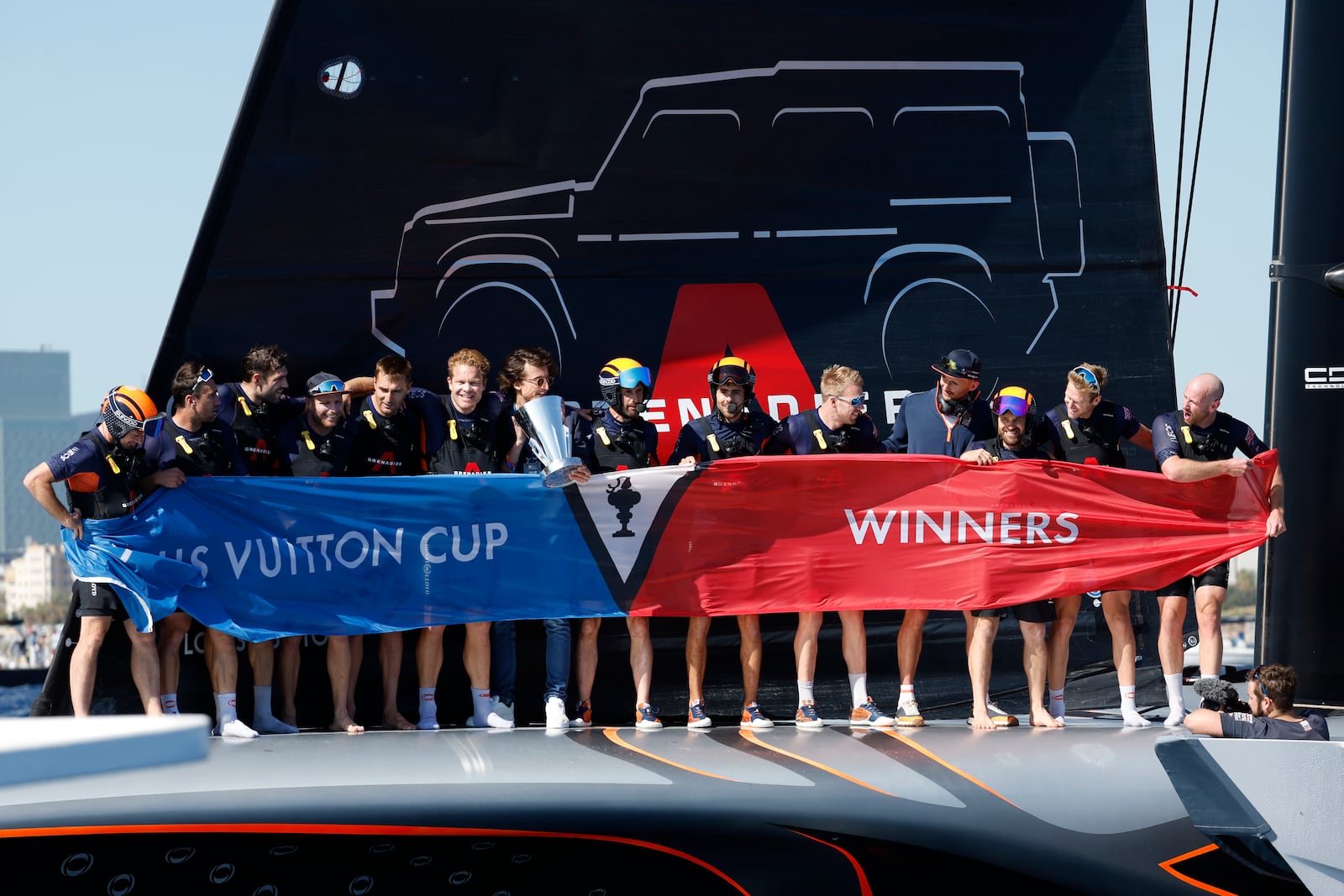 INEOS Britannia crew celebrate their victory against the Luna Rosa Prada Pirelli's sailing team during the Louis Vuitton Cup Final Day 7 at the Barcelona's coast, Spain, Friday, Oct. 4, 2024. (AP Photo/Joan Monfort)