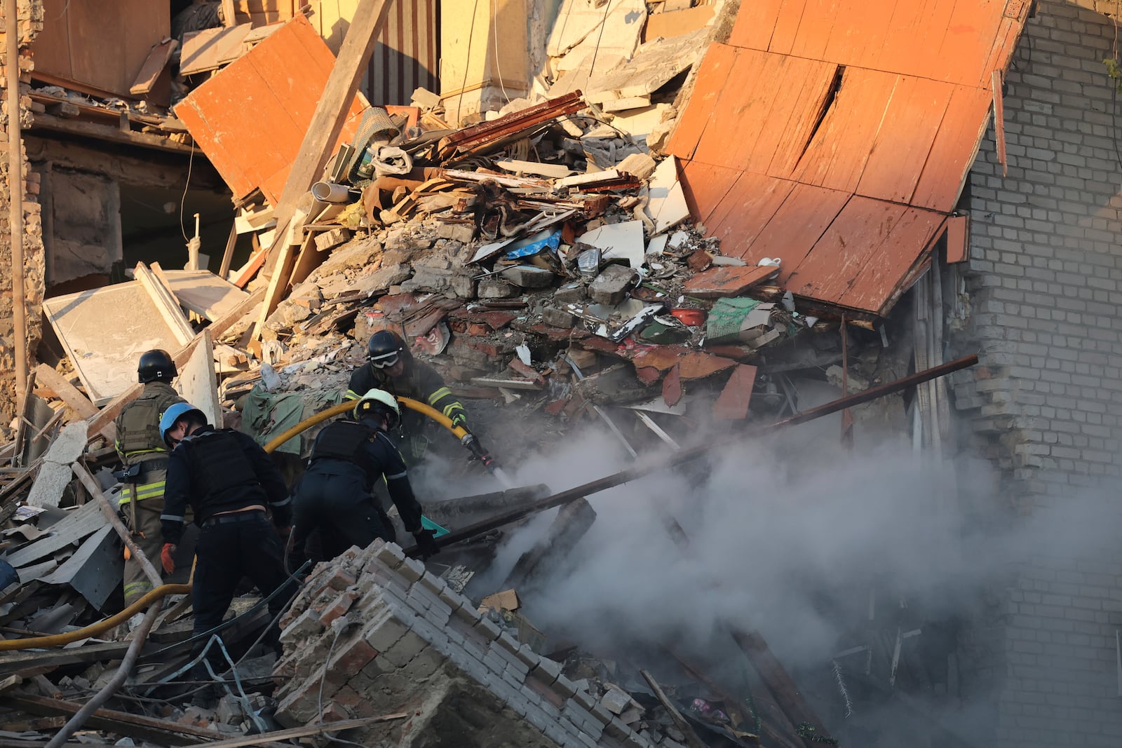 Rescue workers clear the rubble of a residential building destroyed by a Russian airstrike in Zaporizhzhia, Ukraine, Thursday, Nov. 7, 2024. (AP Photo/Kateryna Klochko)