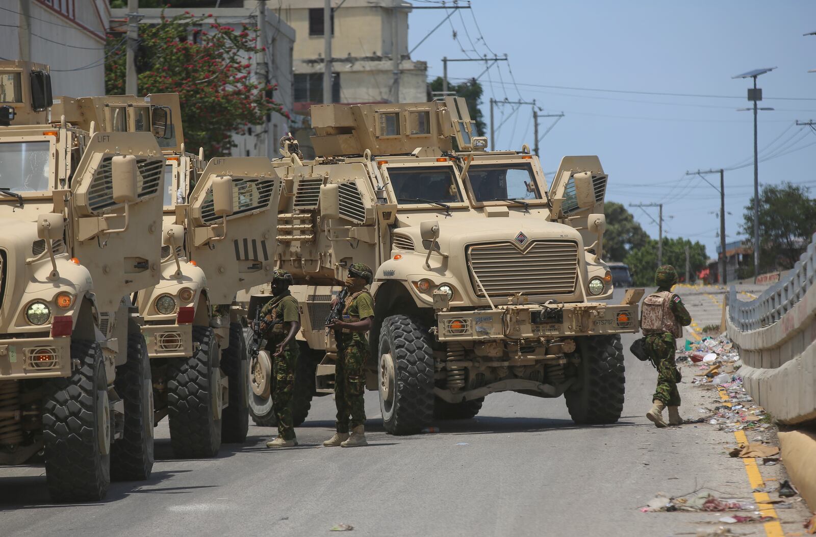 Kenyan police officers, part of a UN-backed multinational, work to tow away a broken down armored car during an operation in the Delmas neighborhood of Port-au-Prince, Haiti, Wednesday, Sept. 4, 2024. (AP Photo/Odelyn Joseph)