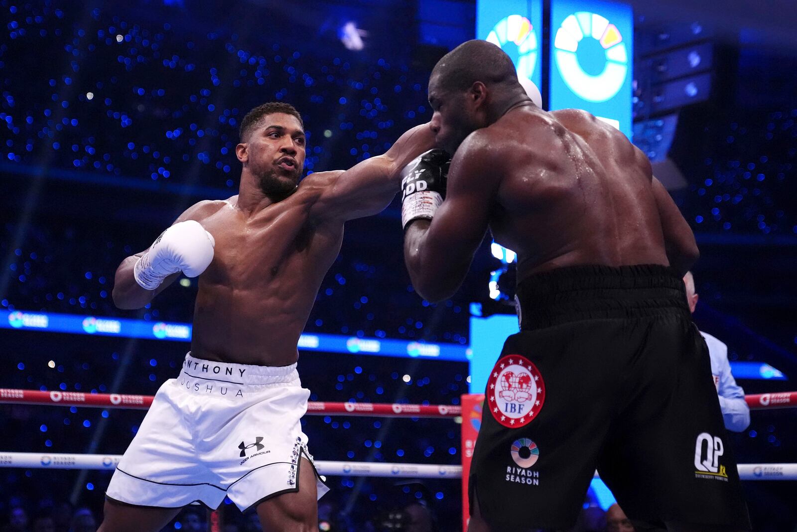 Anthony Joshua, left, and Daniel Dubois fight in the IBF World Heavyweight bout at Wembley Stadium, in London, Saturday, Sept. 21, 2024. (Bradley Collyer/PA via AP)