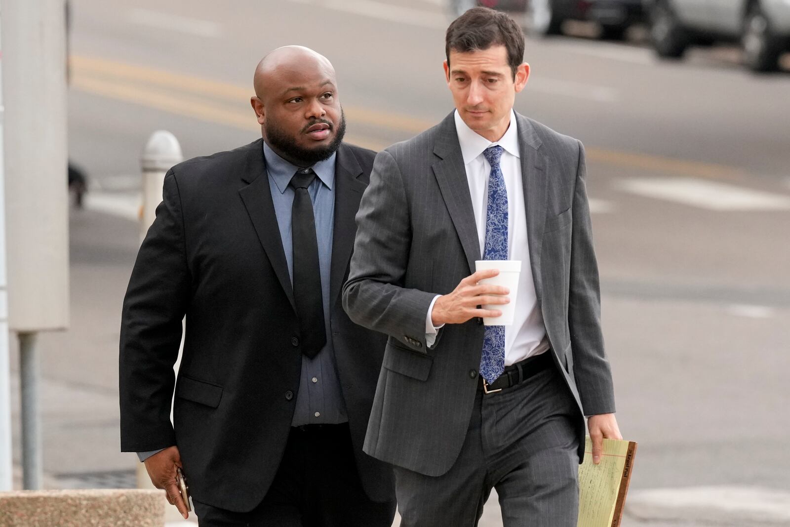 Former Memphis police officer Desmond Mills, left, arrives at the federal courthouse with his attorney Blake Ballin, right, to testify against his former colleagues during the trial in the Tyre Nichols case Wednesday, Sept. 25, 2024, in Memphis, Tenn. (AP Photo/George Walker IV)