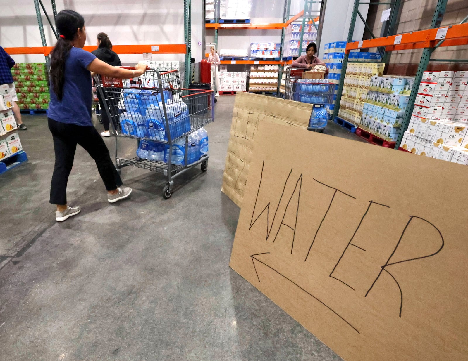 Shoppers load cases of water at the Costco at Costco, Monday, Oct. 7, 2024, in Altamonte Springs, Fla., as residents prepare for the impact of approaching Hurricane Milton. (Joe Burbank/Orlando Sentinel via AP)