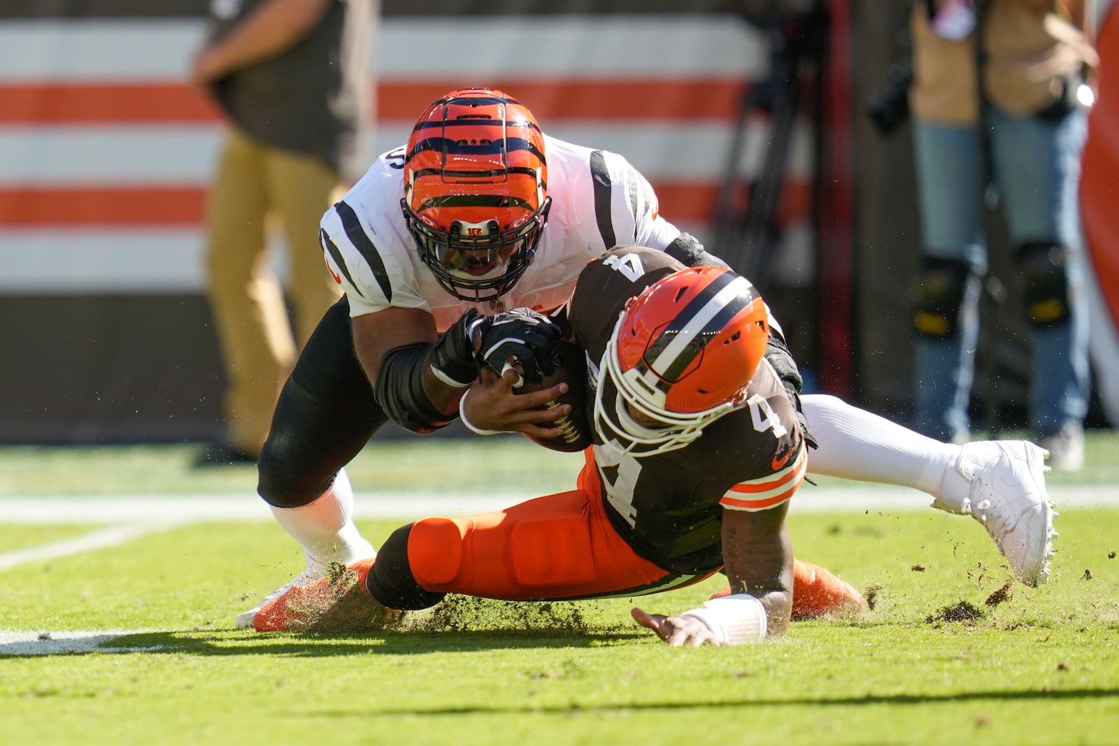 Cleveland Browns quarterback Deshaun Watson (4) is tackled by Cincinnati Bengals defensive tackle Sheldon Rankins in the first half of an NFL football game, Sunday, Oct. 20, 2024, in Cleveland. (AP Photo/Sue Ogrocki)