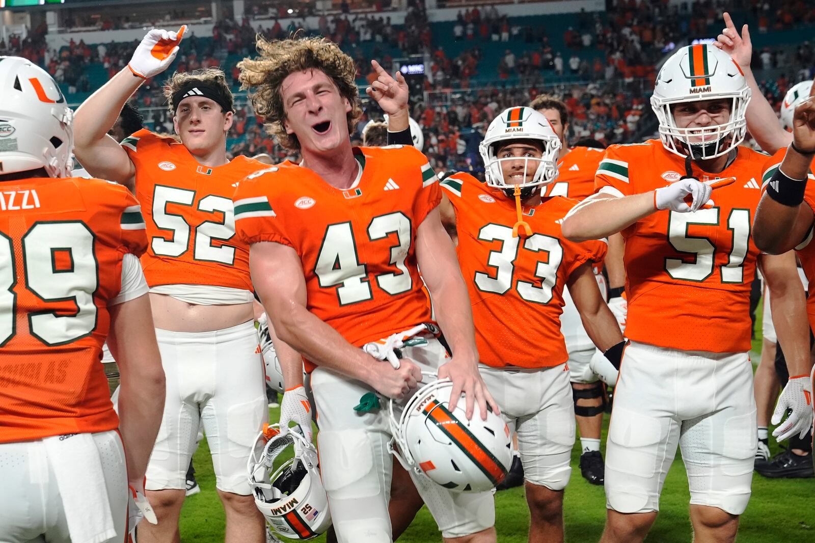 Miami players celebrate after defeating Virginia Tech at an NCAA college football game, Friday, Sept. 27, 2024, in Miami Gardens, Fla. (AP Photo/Marta Lavandier)