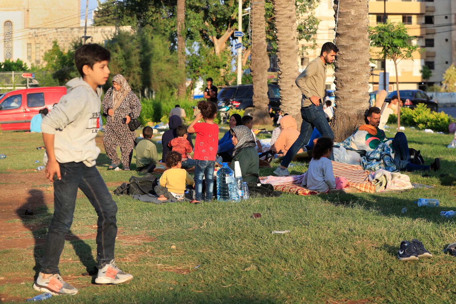 Lebanese citizens who fled the southern villages amid ongoing Israeli airstrikes Monday, settle at a public park in the southern port city of Sidon, Lebanon, Tuesday, Sept. 24, 2024. (AP Photo/Mohammed Zaatari)