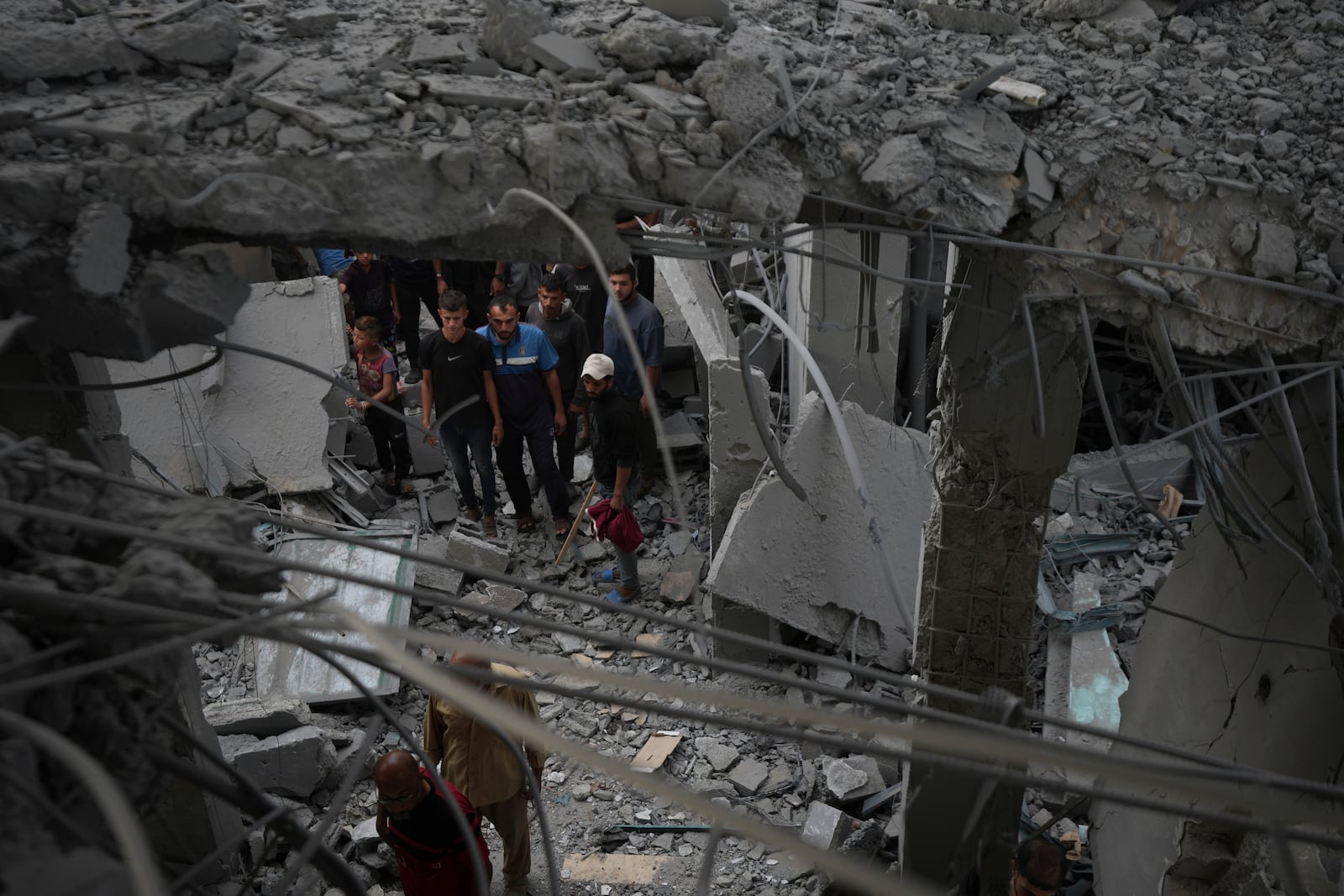 Palestinians examine a destroyed mosque following an Israeli airstrike in Deir al-Balah, Sunday, Oct. 6, 2024. (AP Photo/Abdel Kareem Hana)