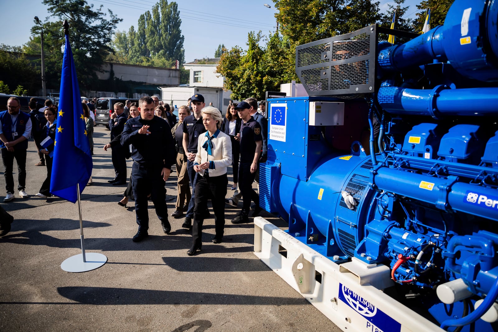 European Commission President Ursula von der Leyen, center, inspects a generator with head of State Emergency Service of Ukraine (SESU)Andriy Danyk during a visit to the headquarters of the State Emergency Service (SESU), in Kyiv, Ukraine, Friday, Sept. 20, 2024. (Christoph Soeder, Pool via AP)