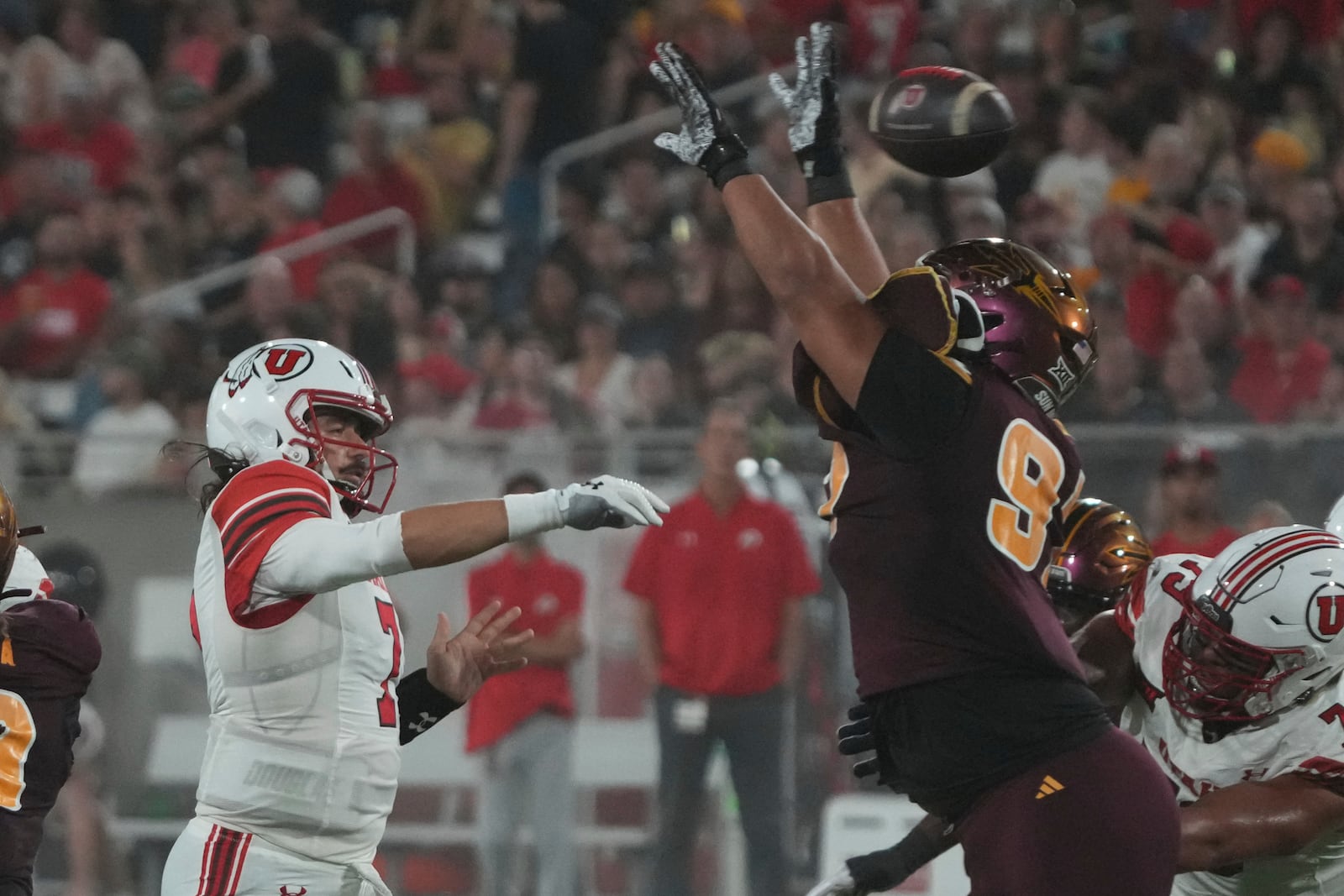 Utah quarterback Cameron Rising throws the ball over Arizona State defensive lineman Blazen Lono-Wong in the first half during an NCAA college football game, Friday, Oct. 11, 2024, in Tempe, Ariz. (AP Photo/Rick Scuteri)