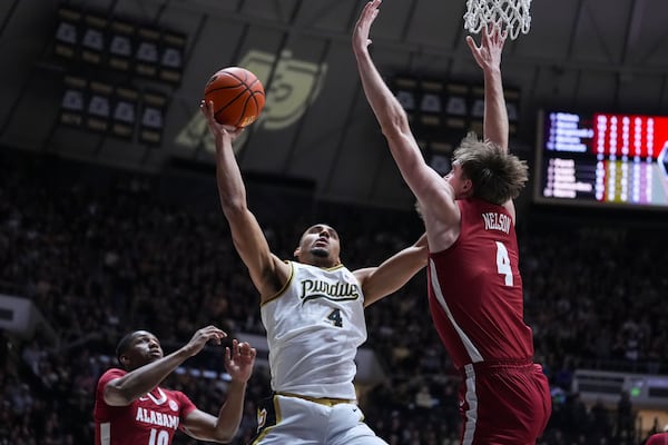 Purdue forward Trey Kaufman-Renn (4) shoots over Alabama forward Grant Nelson (4) during the second half of an NCAA college basketball game in West Lafayette, Ind., Friday, Nov. 15, 2024. (AP Photo/Michael Conroy)