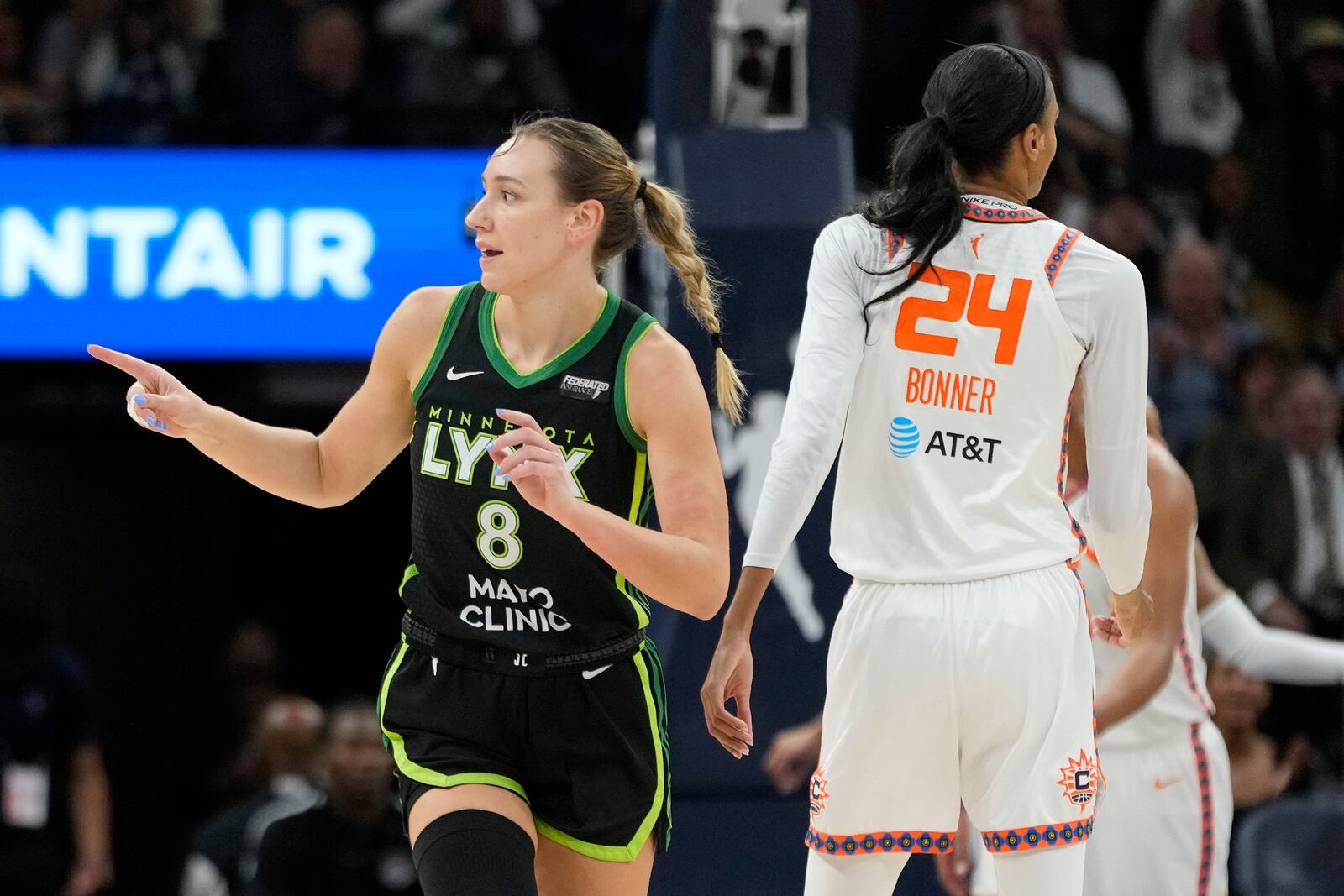 Minnesota Lynx forward Alanna Smith (8) points after making a shot during the first half of Game 5 of a WNBA basketball semifinals game against the Connecticut Sun, Tuesday, Oct. 8, 2024, in Minneapolis. (AP Photo/Abbie Parr)