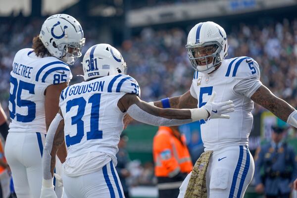 Indianapolis Colts quarterback Anthony Richardson (5) celebrates with running back Tyler Goodson (31) and tight end Drew Ogletree (85) after scoring a touchdown against the New York Jets during the second quarter of an NFL football game, Sunday, Nov. 17, 2024, in East Rutherford, N.J. (AP Photo/Seth Wenig)