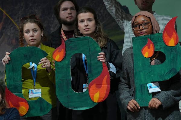 Activist Luisa Neubauer, of Germany, center, participates in a demonstration against fossil fuels at the COP29 U.N. Climate Summit, Friday, Nov. 15, 2024, in Baku, Azerbaijan. (AP Photo/Peter Dejong)