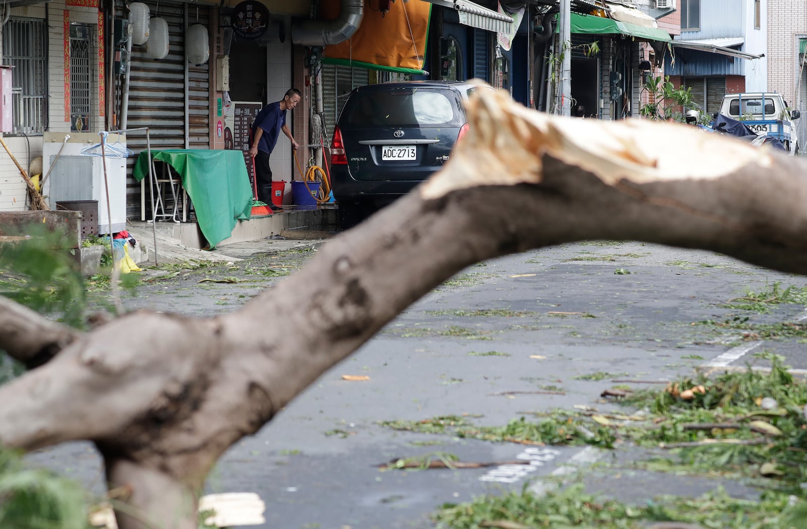 A man clears debris in the aftermath of Typhoon Krathon in Kaohsiung, southern Taiwan, Friday, Oct. 4, 2024. (AP Photo/Chiang Ying-ying)