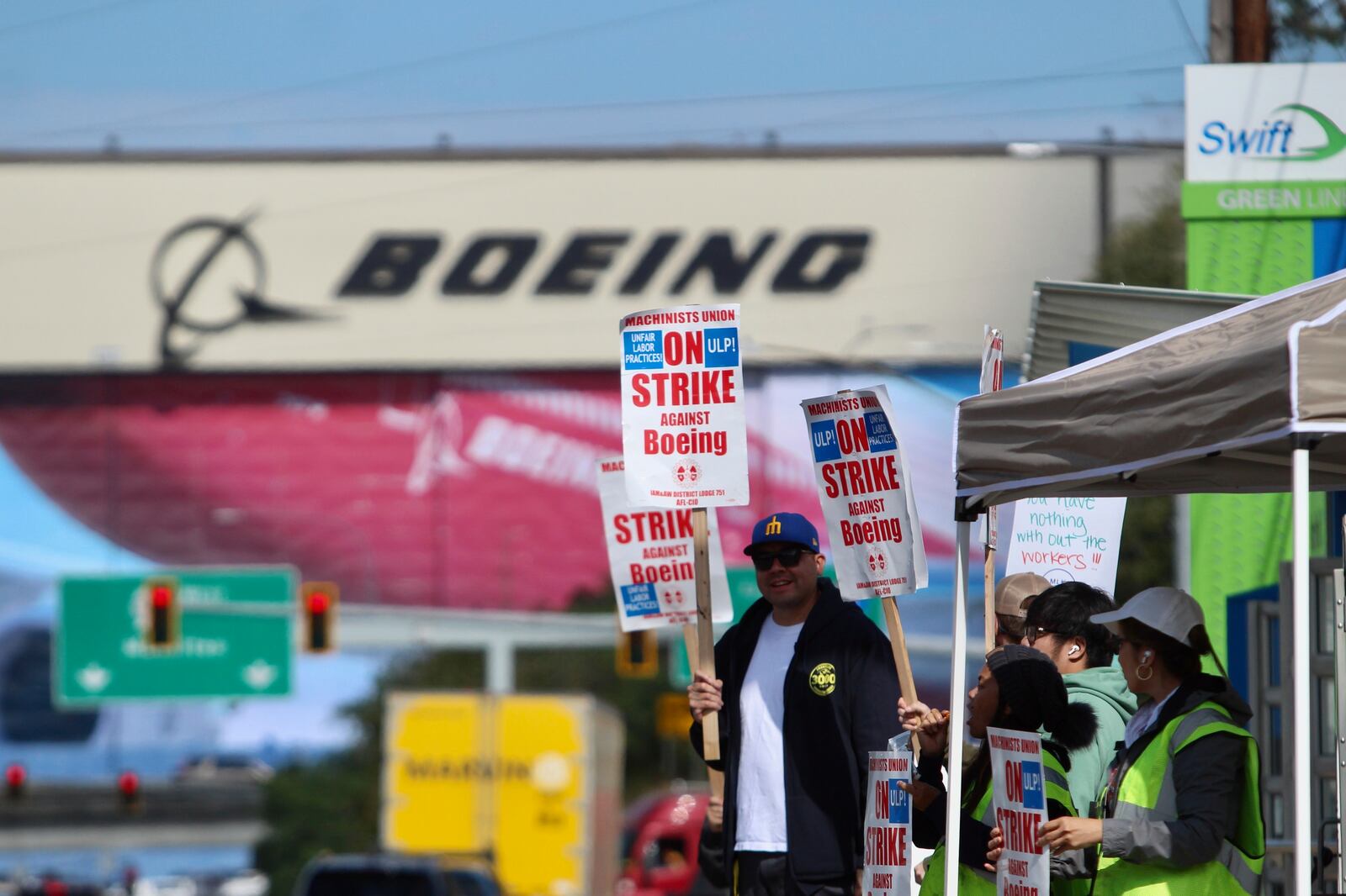 Union machinists and supporters wave picket signs in Everett, Washington, Thursday, Sept. 19, 2024, near a Boeing factory. (AP Photo/Manuel Valdes)