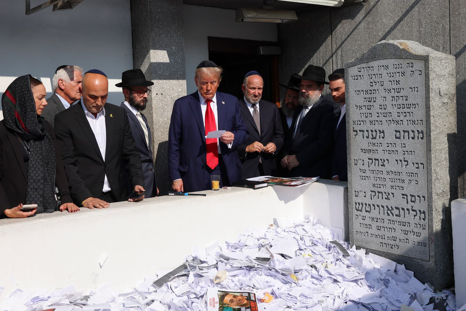 Republican presidential nominee former President Donald Trump, center, visits the gravesite of Rabbi Menachem Mendel Schneerson at Ohel Chabad-Lubavitch, Monday, Oct. 7, 2024, in New York. (AP Photo/Yuki Iwamura)