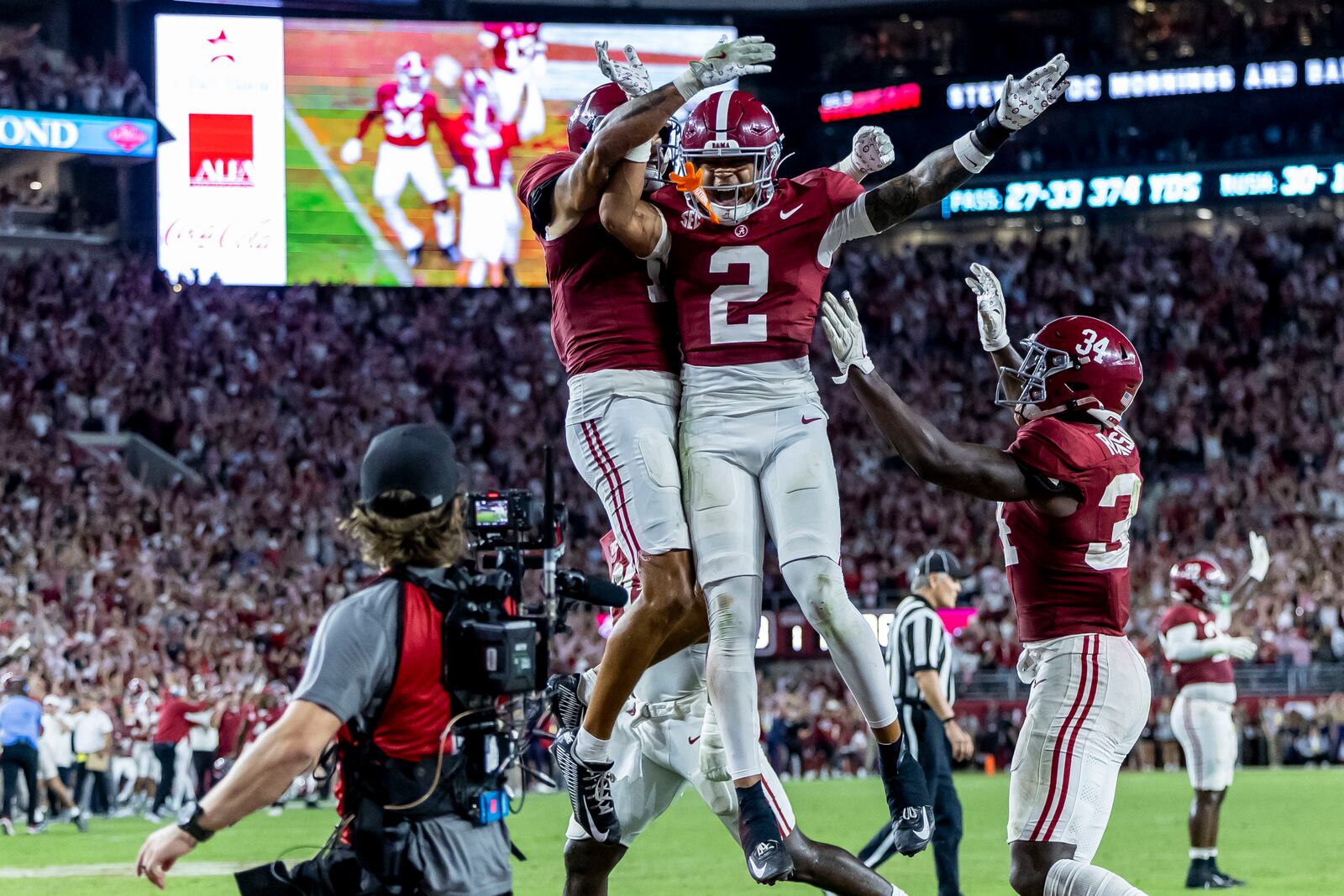 Alabama defensive back Domani Jackson, left, celebrates with defensive back Zabien Brown (2) and linebacker Que Robinson (34) after Brown intercepted a pass in the final minute during the second half of an NCAA college football game against Georgia, Saturday, Sept. 28, 2024, in Tuscaloosa, Ala. (AP Photo/Vasha Hunt)