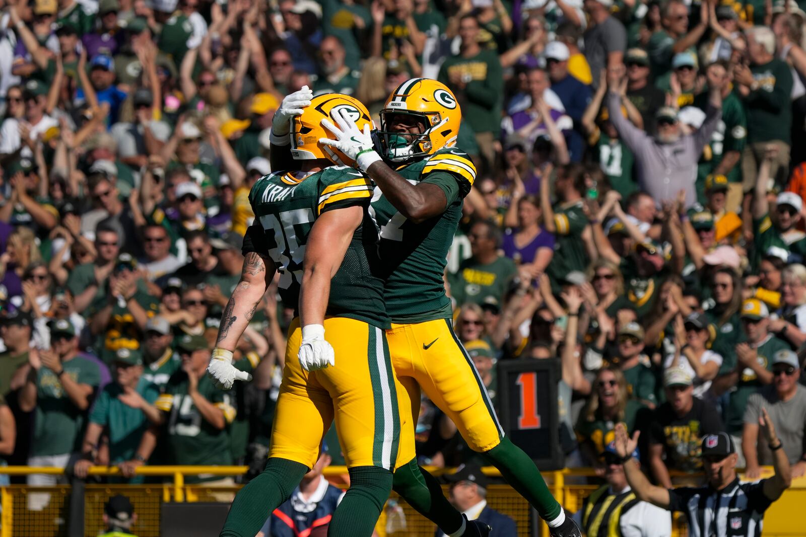 Green Bay Packers tight end Tucker Kraft, left, and wide receiver Romeo Doubs, right, celebrate a touchdown during the second half of an NFL football game against the Minnesota Vikings, Sunday, Sept. 29, 2024, in Green Bay, Wis. (AP Photo/Morry Gash)