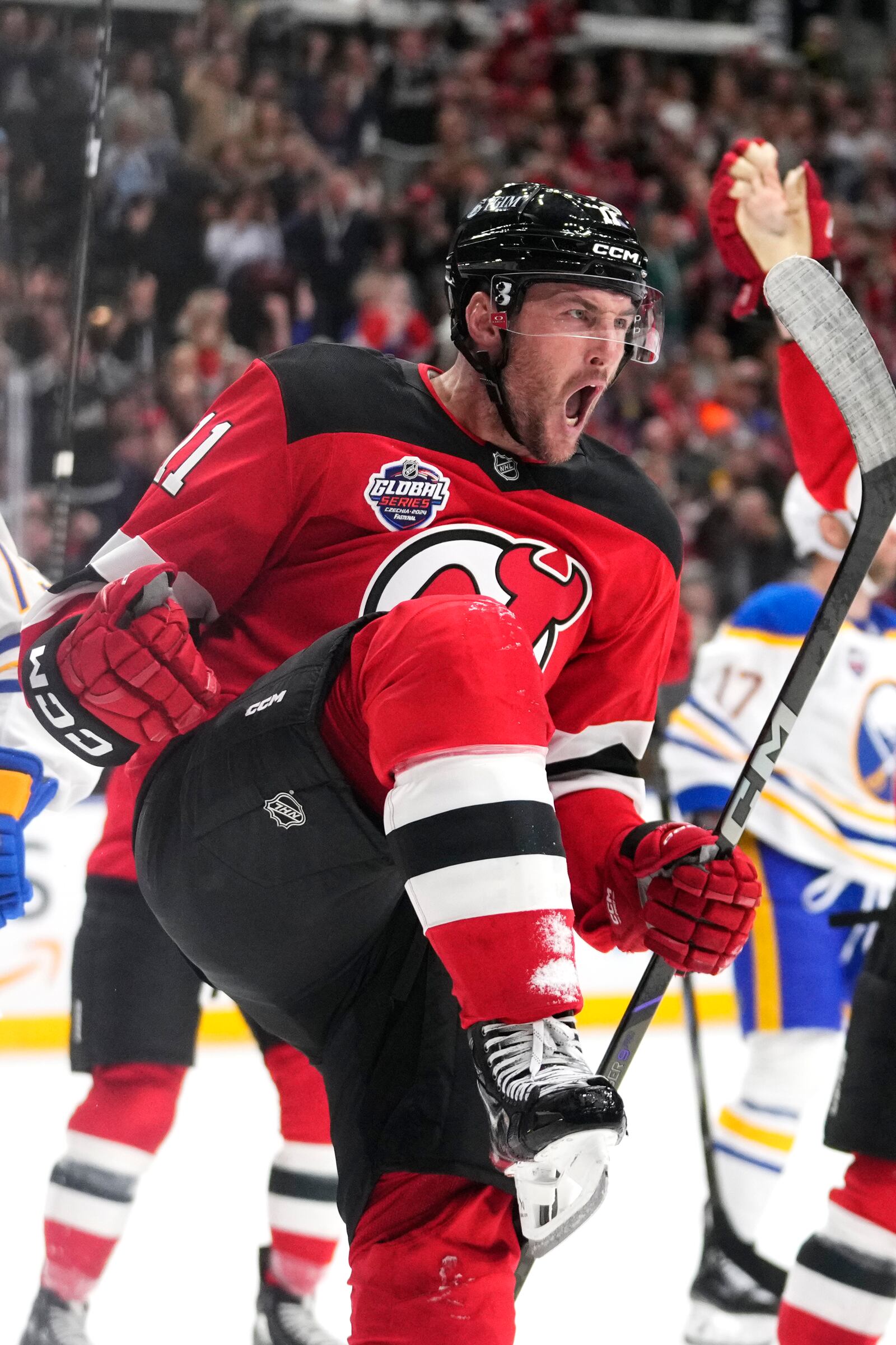 New Jersey Devils' Stefan Noesen celebrates after scoring the opening goal during the NHL hockey game between Buffalo Sabres and New Jersey Devils, in Prague, Czech Republic, Friday, Oct. 4, 2024. (AP Photo/Petr David Josek)